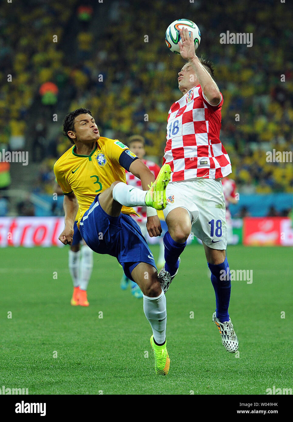 Thiago Silva (L) of Brazil in action with Ivica Olic of Croatia during the 2014 FIFA World Cup Group A match at the Arena Corinthians in Sao Paulo, Brazil on June 12, 2014. UPI/Chris Brunskill Stock Photo