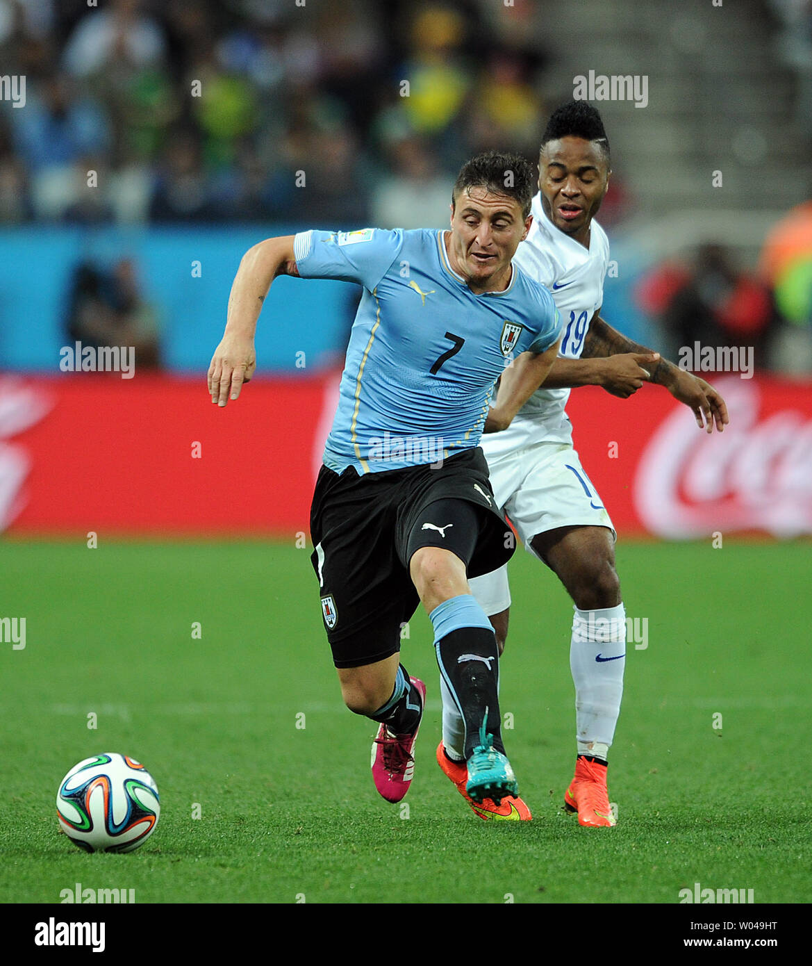 Cristian Rodriguez (L) of Uruguay competes with Raheem Sterling of England during the 2014 FIFA World Cup Group D match at the Arena Corinthians in Sao Paulo, Brazil on June 19, 2014. UPI/Chris Brunskill Stock Photo