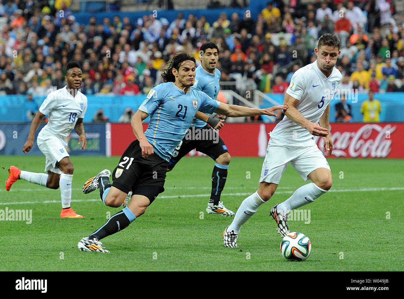 Edinson Cavani (L) of Uruguay competes with Gary Cahill of England during the 2014 FIFA World Cup Group D match at the Arena Corinthians in Sao Paulo, Brazil on June 19, 2014. UPI/Chris Brunskill Stock Photo