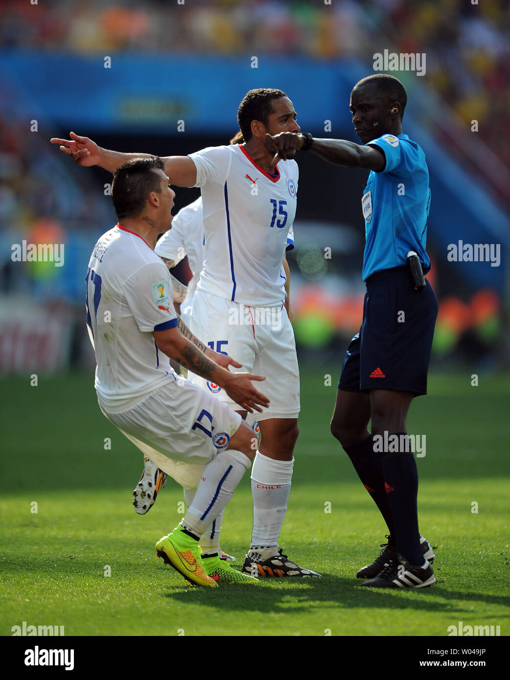 Jean Beausejour and Gary Medel (L) of Chile appeal to referee Bakary Gassama during the 2014 FIFA World Cup Group B match at the Arena Corinthians in Sao Paulo, Brazil on June 23, 2014. UPI/Chris Brunskill Stock Photo