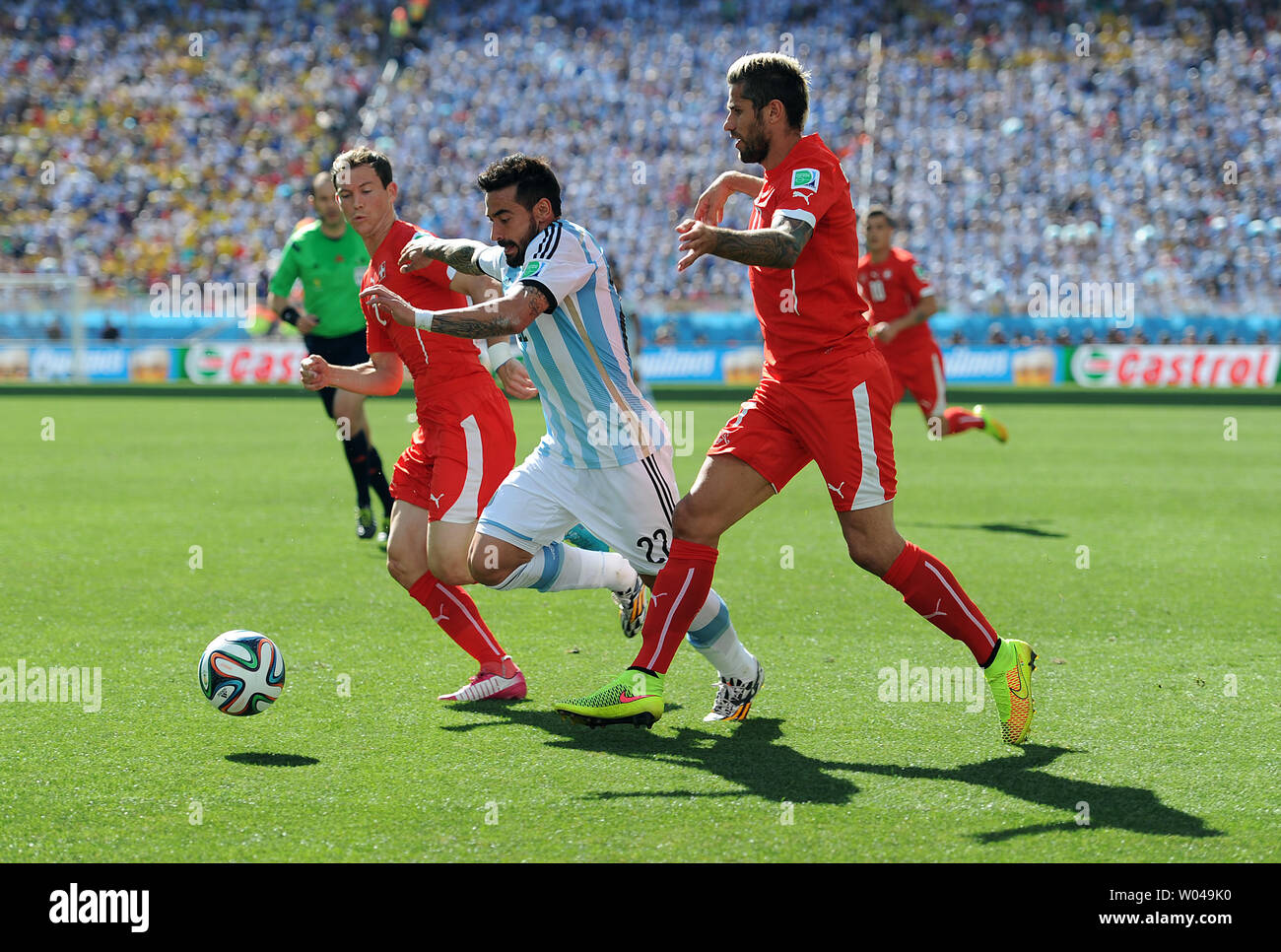Ezequiel Lavezzi (C) of Argentina competes with Valon Behrami of Switzerland during the 2014 FIFA World Cup Round of 16 match at the Arena Corinthians in Sao Paulo, Brazil on July 01, 2014. UPI/Chris Brunskill Stock Photo