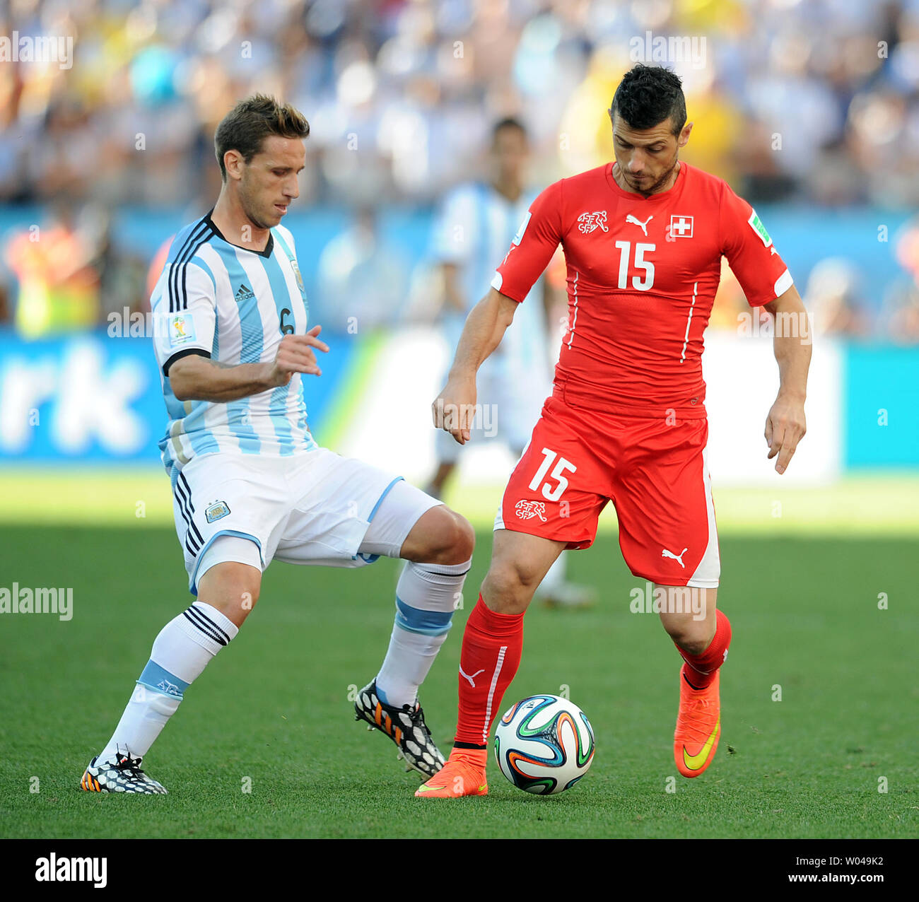 Lucas Biglia (L) of Argentina competes with Blerim Dzemaili of Switzerland during the 2014 FIFA World Cup Round of 16 match at the Arena Corinthians in Sao Paulo, Brazil on July 01, 2014. UPI/Chris Brunskill Stock Photo