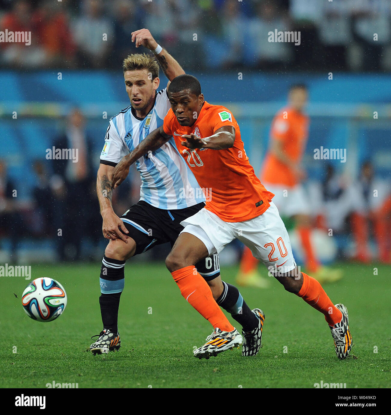 Georginio Wijnaldum of the Netherlands competes with Lucas Biglia (L) of Argentina during the 2014 FIFA World Cup Semi Final match at the Arena Corinthians in Sao Paulo, Brazil on July 09, 2014. UPI/Chris Brunskill Stock Photo
