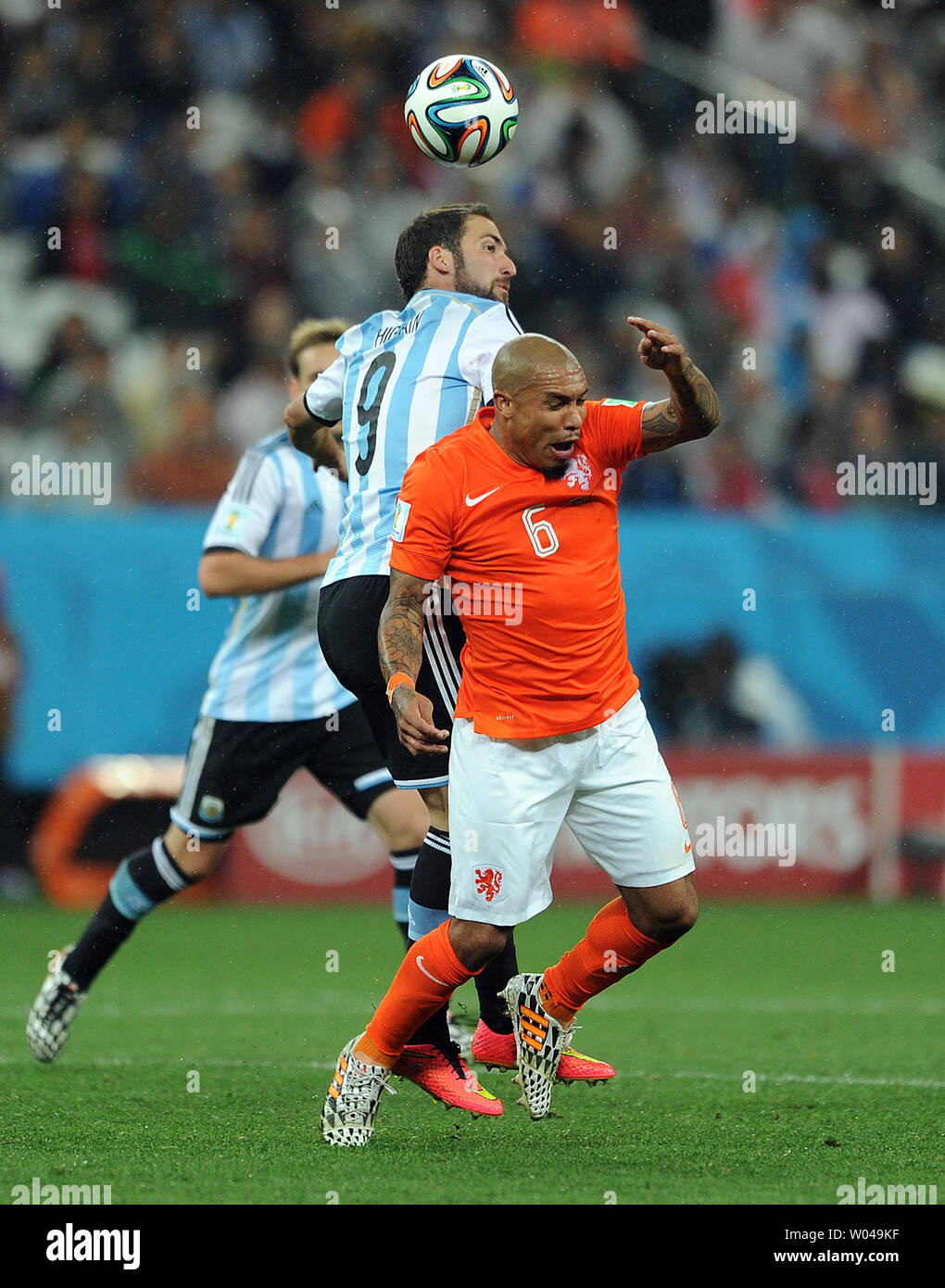 Nigel De Jong of the Netherlands competes with Gonzalo Higuain (L) of Argentina during the 2014 FIFA World Cup Semi Final match at the Arena Corinthians in Sao Paulo, Brazil on July 09, 2014. UPI/Chris Brunskill Stock Photo
