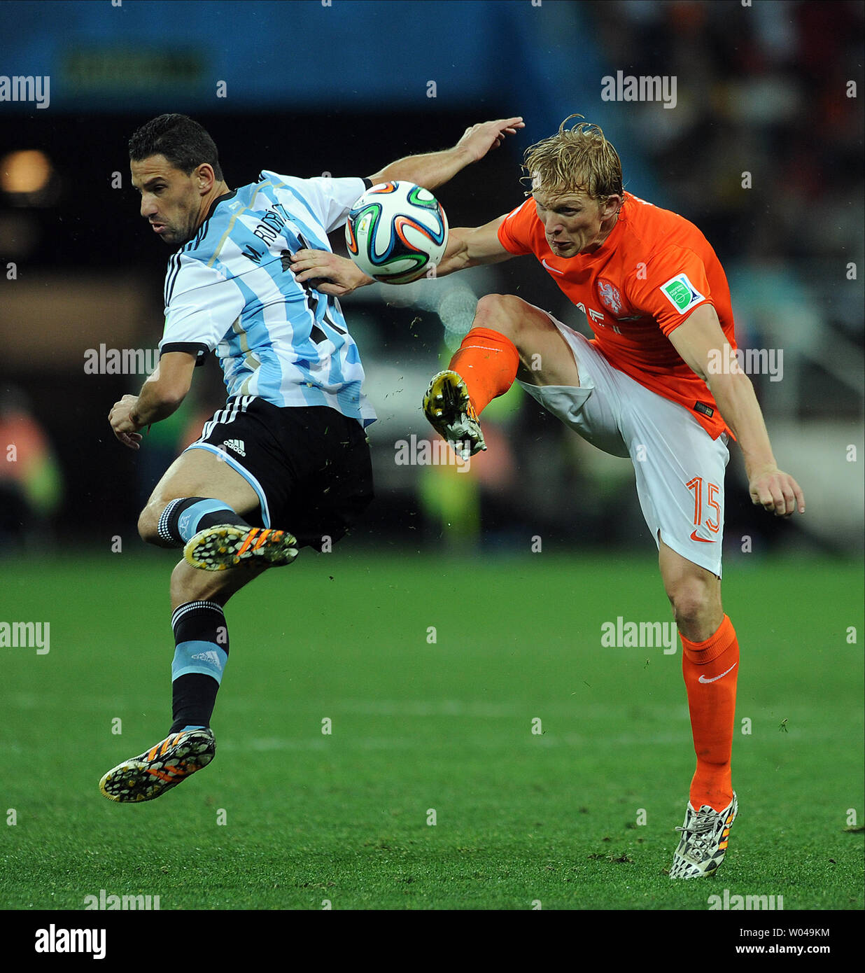 Dirk Kuyt of the Netherlands competes with Maxi Rodriguez (L) of Argentina during the 2014 FIFA World Cup Semi Final match at the Arena Corinthians in Sao Paulo, Brazil on July 09, 2014. UPI/Chris Brunskill Stock Photo
