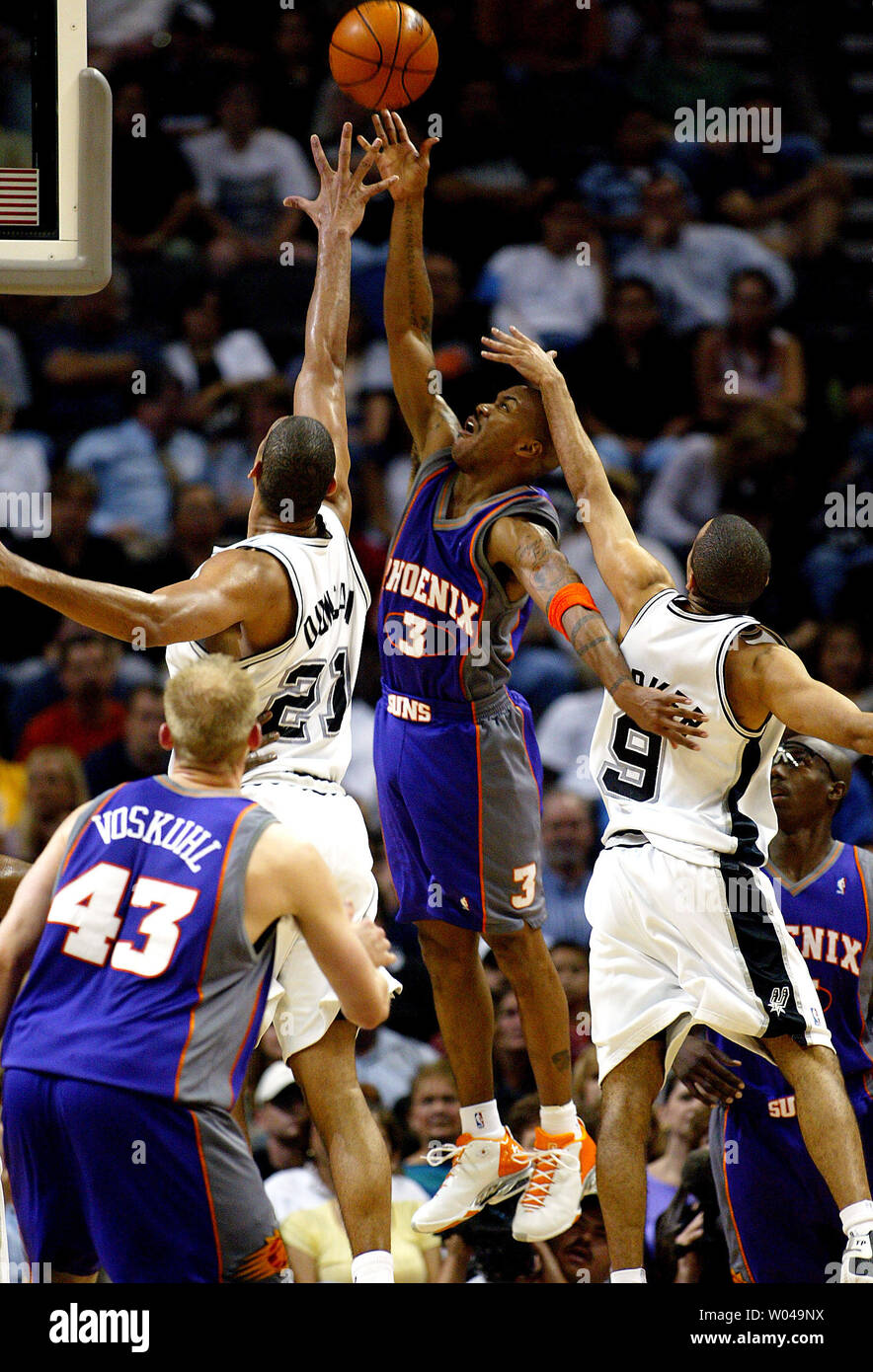 San Antonio Spurs' Manu Ginobili (20), of Argentina, looks to pass the ball  as Phoenix Suns' Amare Stoudemire (32) and Shawn Marion, left, defend  during Game 4 of the Western Conference Finals