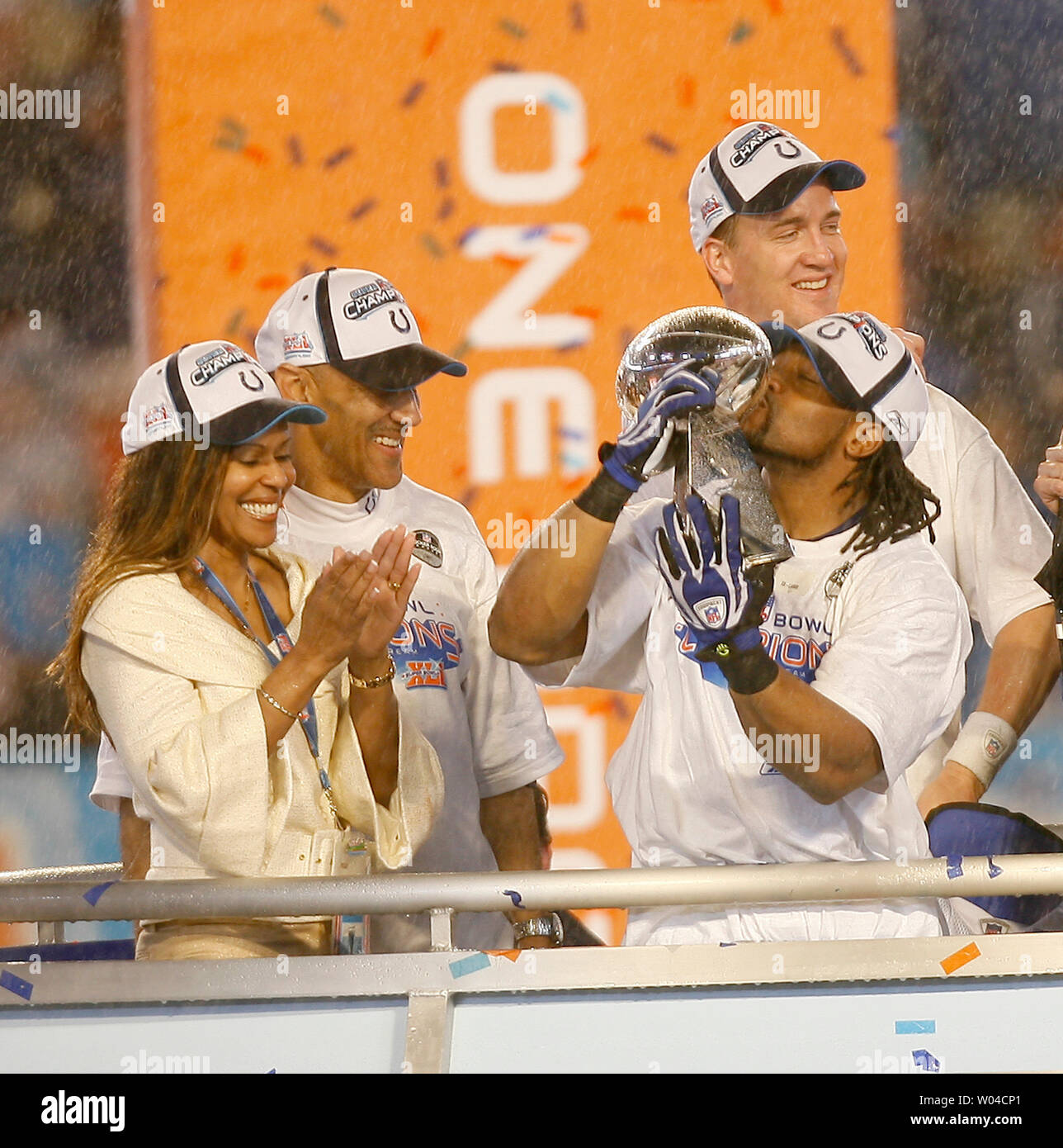 Indianapolis Colts Bob Sanders kisses the Vince Lombardi trophy as coach  Tony Dungy, his wife and Peyton Manning look on at Super Bowl XLI at  Dolphin Stadium in Miami on February 4,