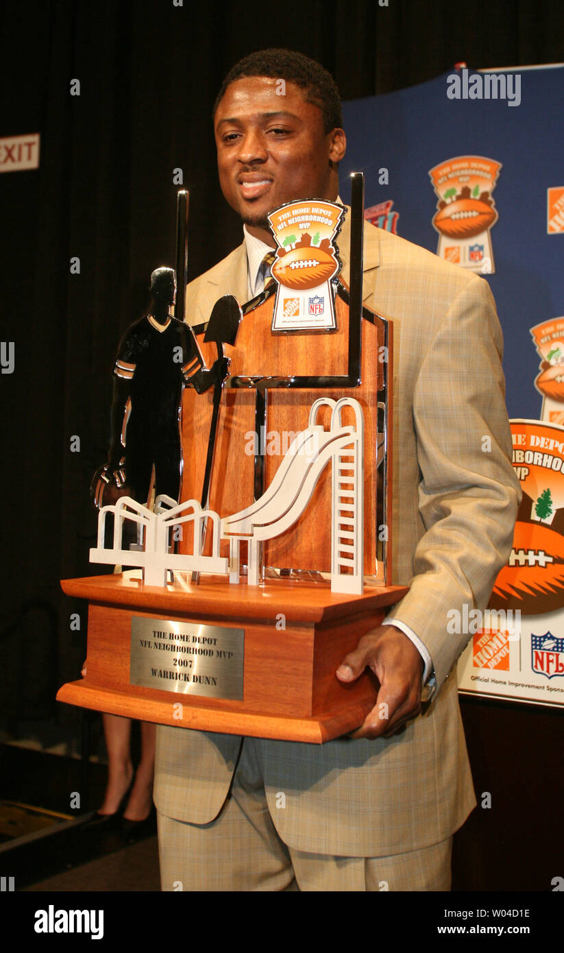 Atlanta Falcons Warrick Dunn holds the trophy awarded along with the Home  Depot NFL Neighborhood MVP Award in Phoenix, Arizona on January 30, 2008.  The title and $25,000 was given to Dunn's