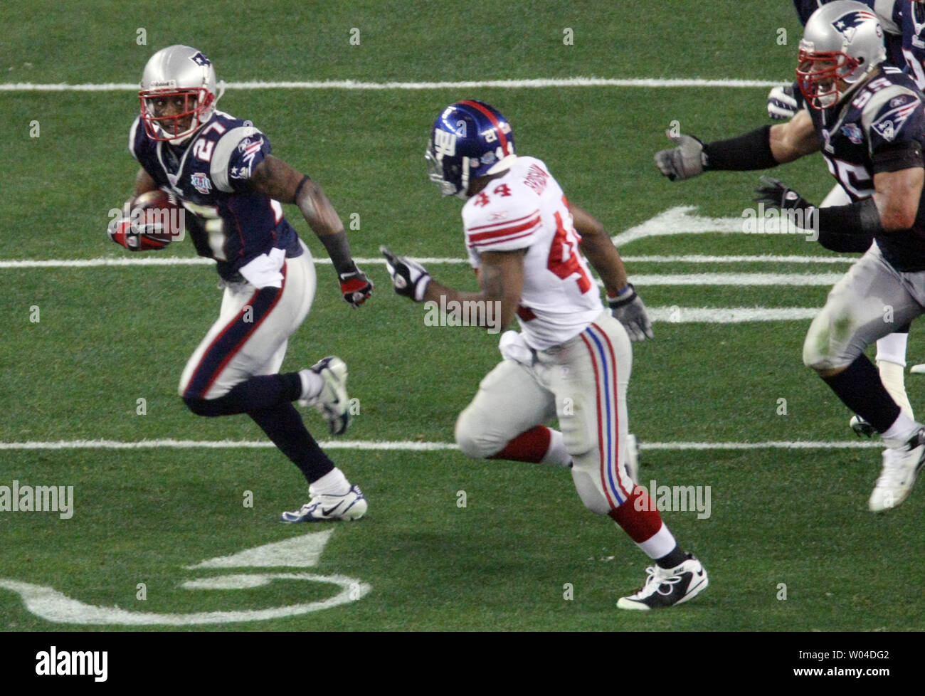 New England Patriots cornerback Ellis Hobbs III (L) runs the ball after he intercepted a pass intended for New York Giants wide receiver Steve Smith in the second quarter during Super Bowl XLII at University of Phoenix Stadium in Glendale, Arizona on February 3, 2008. (UPI Photo/Jon SooHoo) Stock Photo