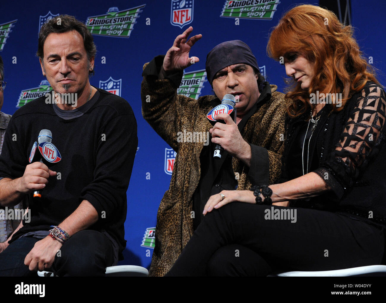 L to R)Bruce Springsteen, Steven Van Zandt and Patti Scialfa, backed by  other members of the E Street Band, speak to the media about their upcoming  half time performance at Super Bowl
