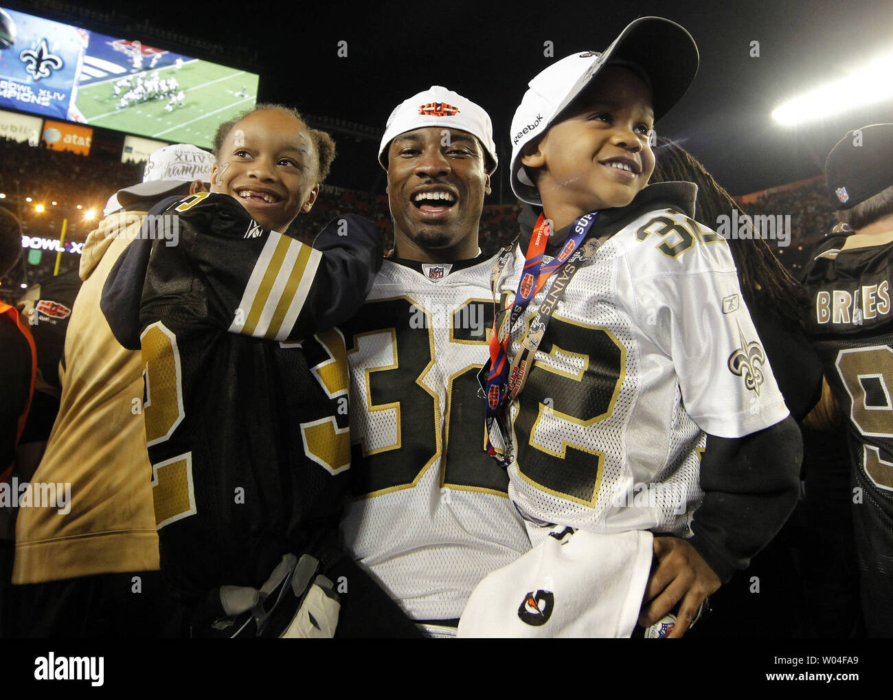 New Orleans Saints corner back Jabari Greer holds his children