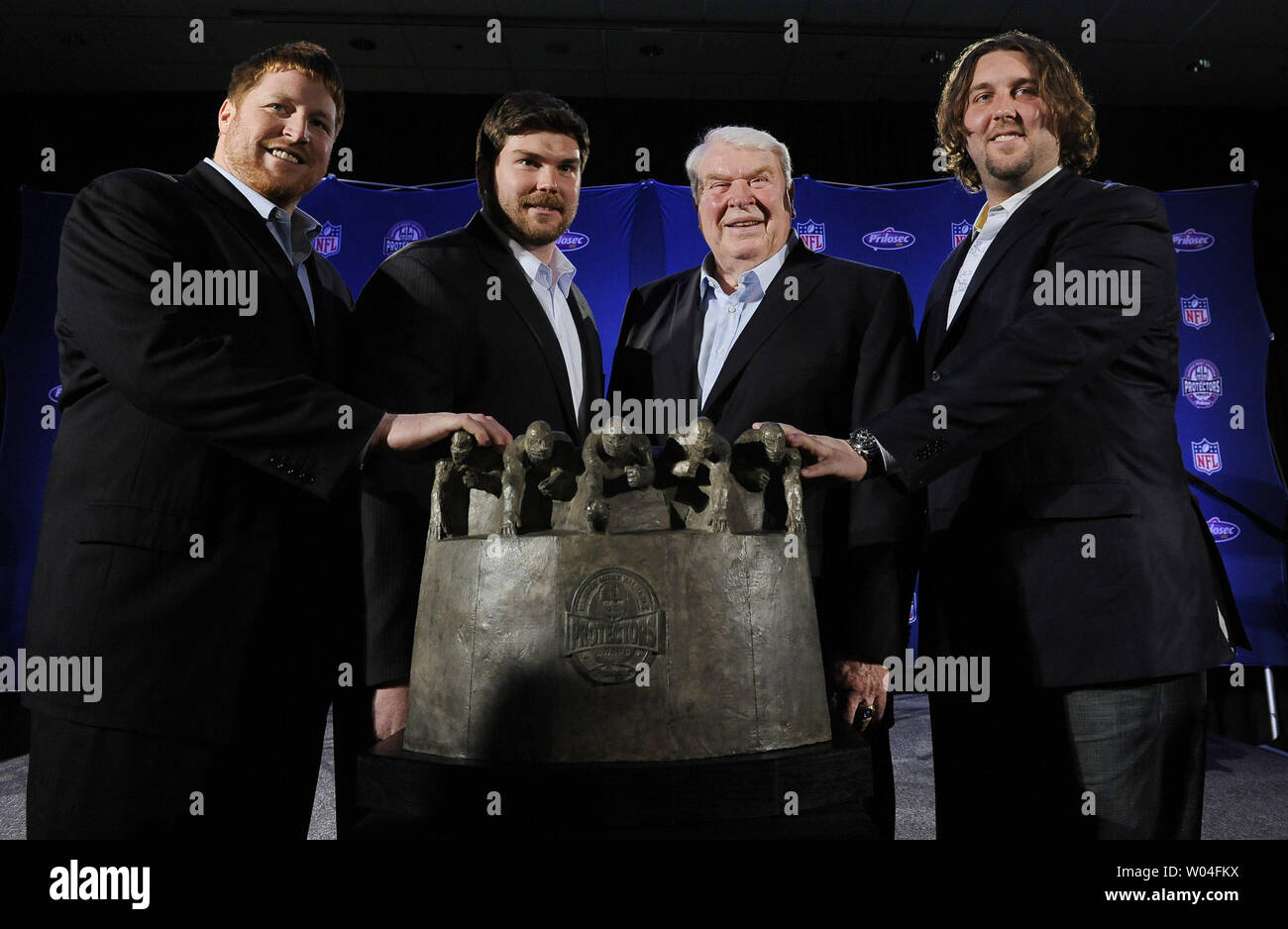 Dan Koppen (L), Dan Connolly (LC) and Mark LeVoir (R),  stand with John Madden (RC) and the award after the New England Patriots won the Madden Most Valuable Protectors Award as the year's best offensive line during the week of Super Bowl XLV in Dallas, Texas, on February 3, 2011. The Pittsburgh Steelers will take on the Green Bay Packers on February 6, 2011.    UPI/Roger L. Wollenberg Stock Photo