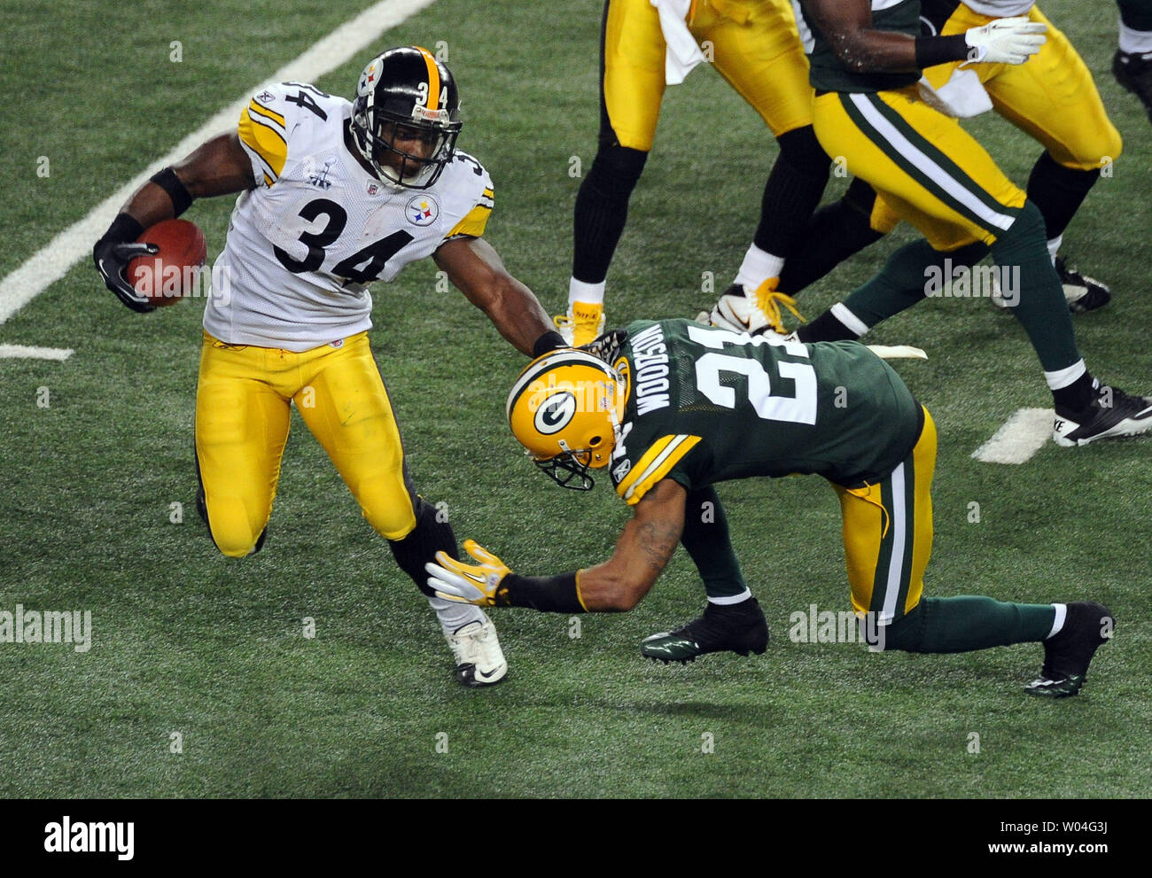 Pittsburgh Steelers runningback Rashard Mendenhall is tackled by Green Bay  Packers cornerback Charles Woodson in the first half during Super Bowl XLV  at Cowboys Stadium in Arlington, Texas on February 6, 2011.