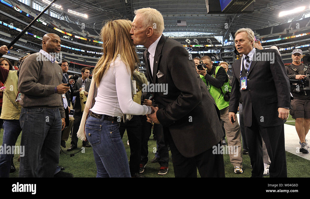 Dallas Cowboys owner Jerry Jones leans over to plant a kiss on actress Jennifer Aniston during Super Bowl XLV pre-game activities at Cowboys Stadium in Arlington, Texas  on February 6, 2011.     UPI/Brian Kersey Stock Photo