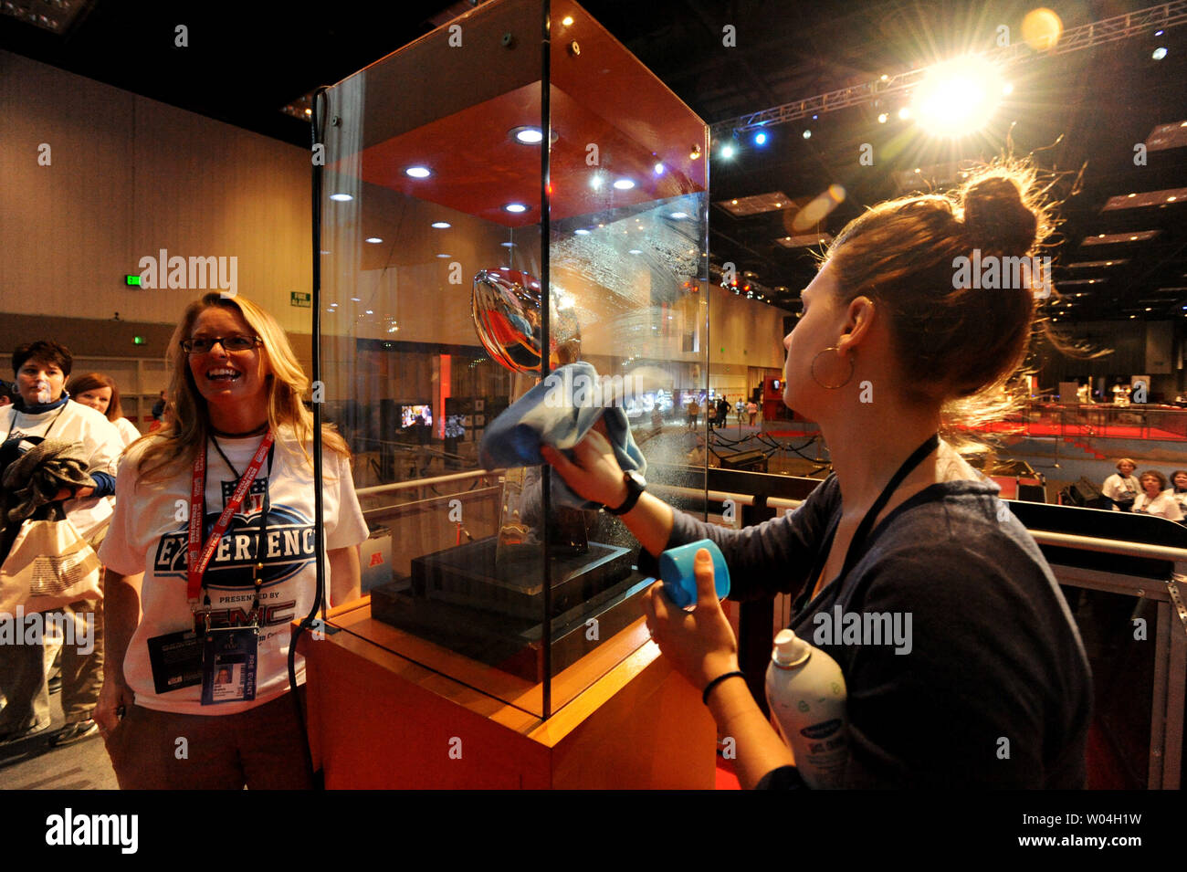 Maria Porter, of Indianapolis, cleans the glass as NFL fans line up to get their picture taken with the NFL Super Bowl Championship Lombardi Trophy at the NFL Experience at the Indianapolis Convention Center in downtown Indianapolis, Indiana on February 3, 2012.   The New England Patriots play the New York Giants in the Super Bowl on February 5, 2012.   UPI/Pat Benic Stock Photo