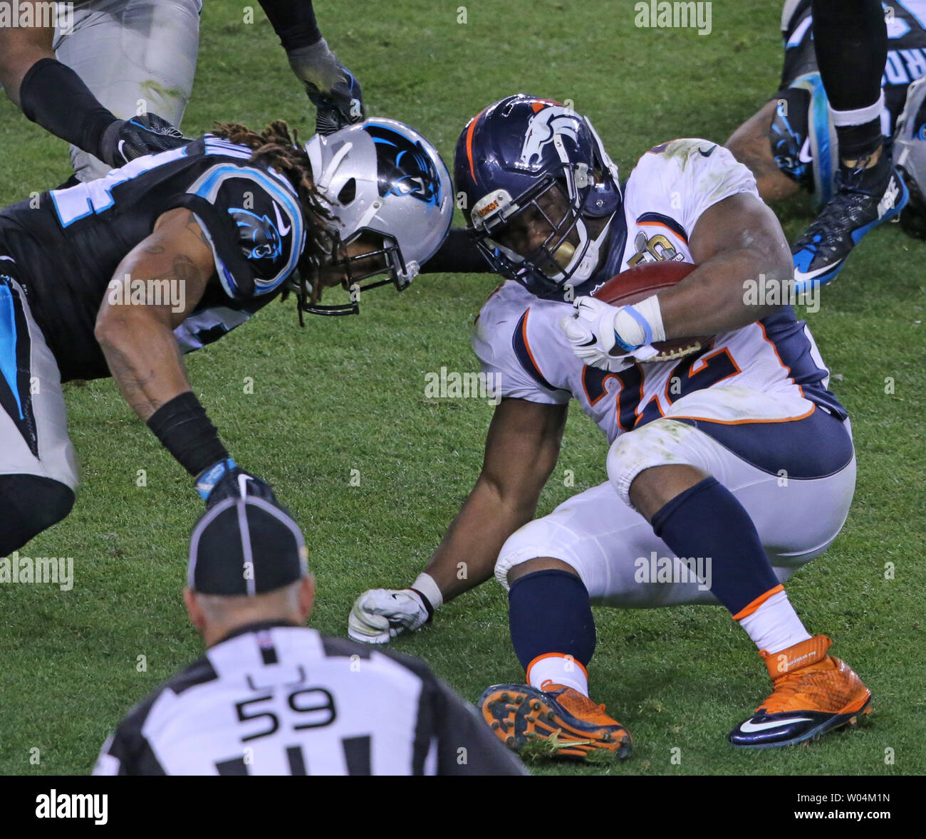 Carolina Panthers Kony Ealy (L) goes helmet to helmet with Denver Broncos C.J. Anderson (22) after a short gain in the fourth quarter of Super Bowl 50 at Levi's Stadium in Santa Clara, California, February 7, 2015.  The Denver Broncos defeated the Carolina Panthers 24-10.     Photo by Khaled Sayed/UPI Stock Photo