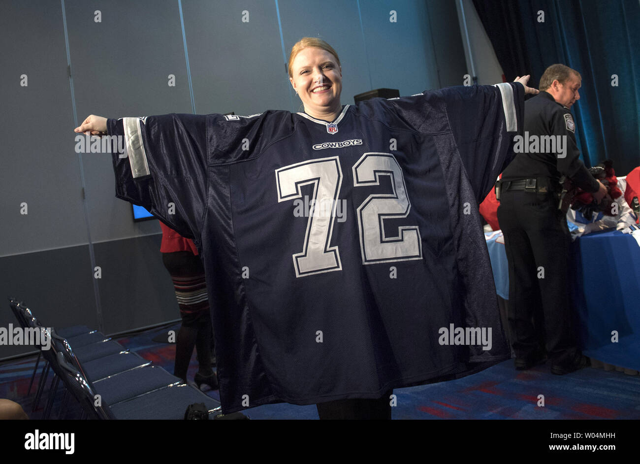 A woman wears a counterfeit 10XL Cowboys jersey at a press conference on  NFL counterfeit merchandise and tickets, in Houston, Texas on February 2,  2017. Officials with the NFL, Department of Homeland