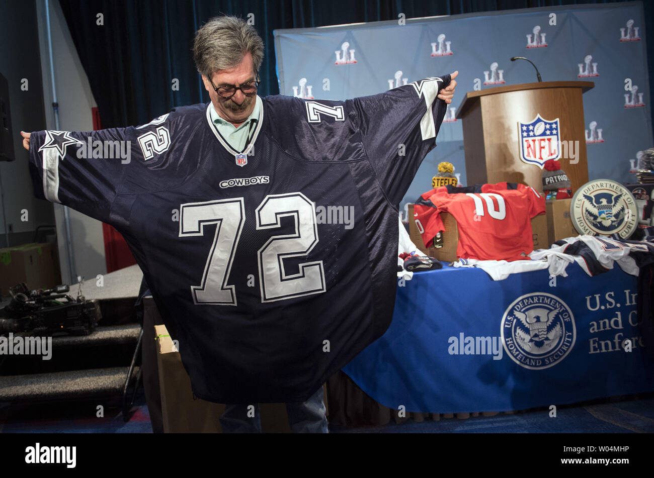 A man wears a counterfeit 10XL Cowboys jersey at a press conference on NFL  counterfeit merchandise and tickets, in Houston, Texas on February 2, 2017.  Officials with the NFL, Department of Homeland
