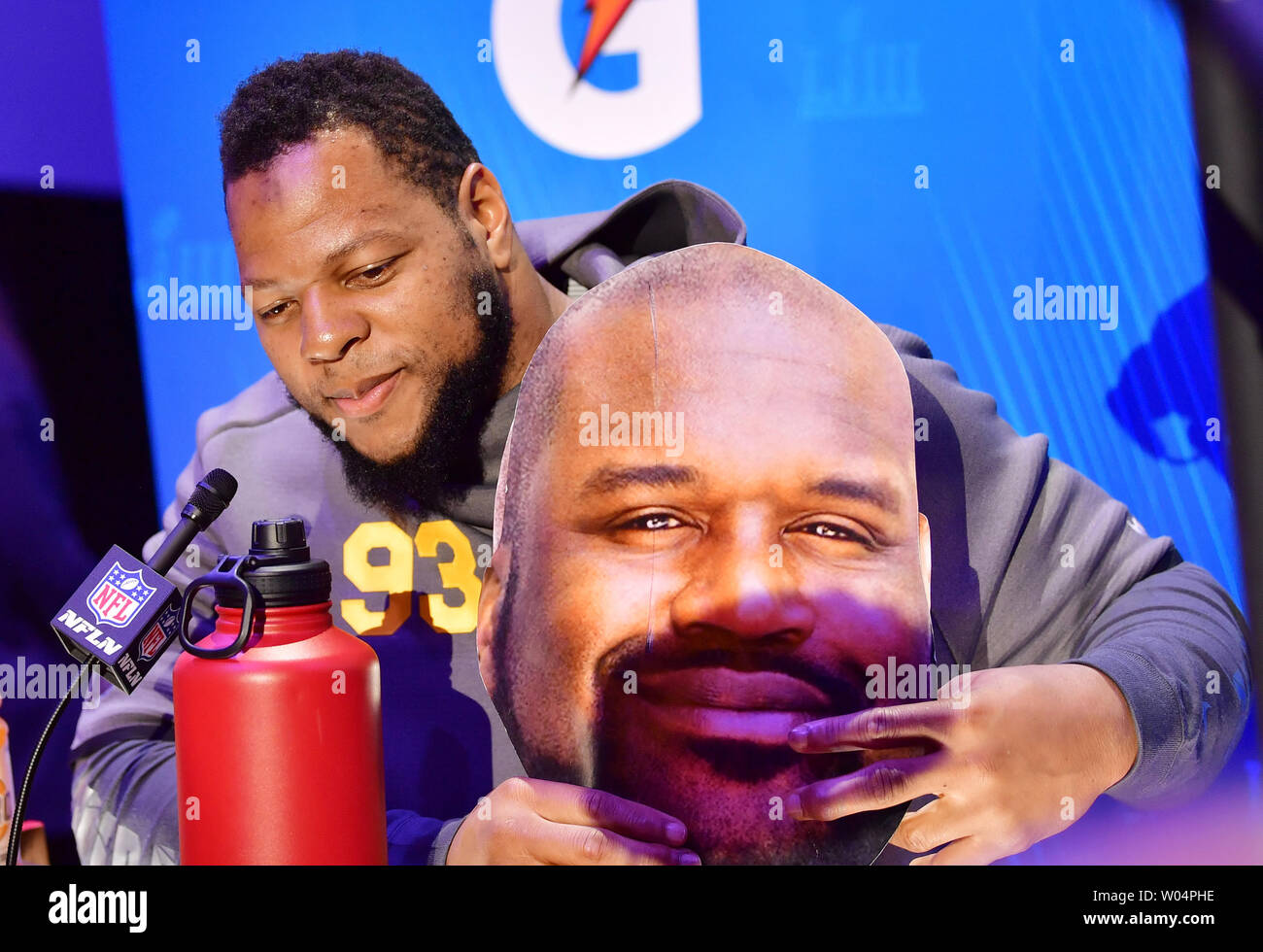 Los Angeles Rams Ndamukong Suh holds a cardboard cutout of Shaquille O'Neal  when he speaks to the media during Super Bowl Opening Night at the State  Farm Arena on January 28, 2019