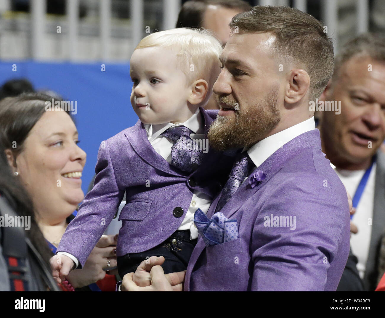 MMA star Conor McGregor watches warm ups holding his son, Conor Jack