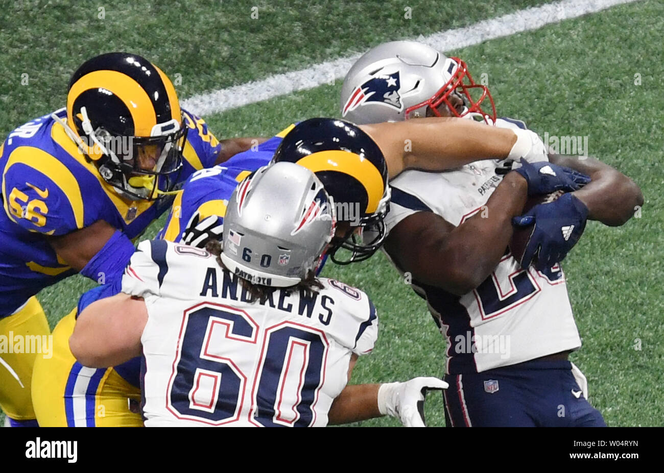 New England Patriots running back Sony Michel (26) is tackled by Los Angeles Rams defenders during the first quarter of Super Bowl LIII at Mercedes-Benz Stadium in Atlanta on February 3, 2019.   Photo by Jon SooHoo/UPI Stock Photo