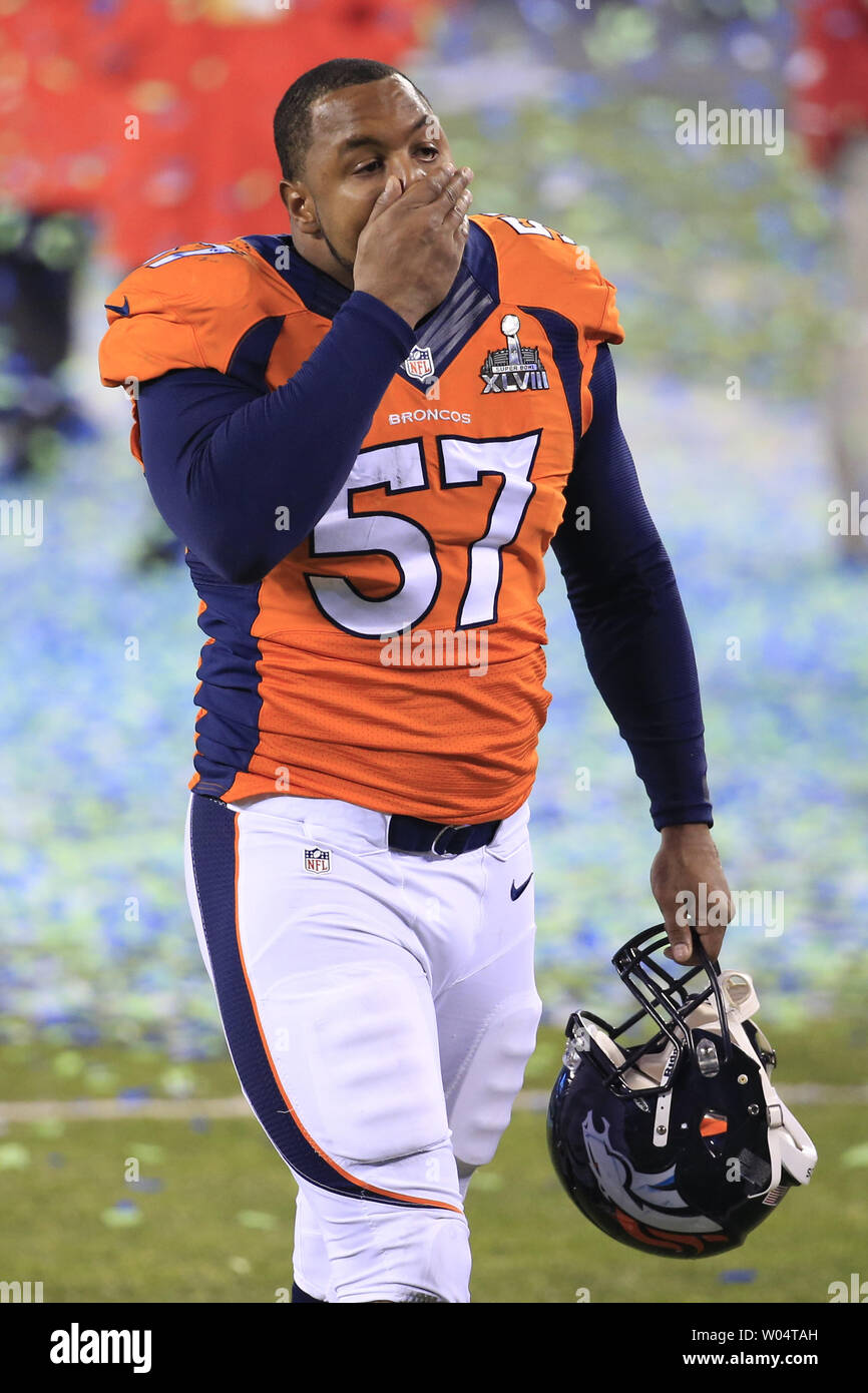 Denver Broncos defensive end Jeremy Mincey (57) wipes his face as he walks  off the field following the Super Bowl XLVIII at MetLife Stadium in East  Rutherford, New Jersey on February 2