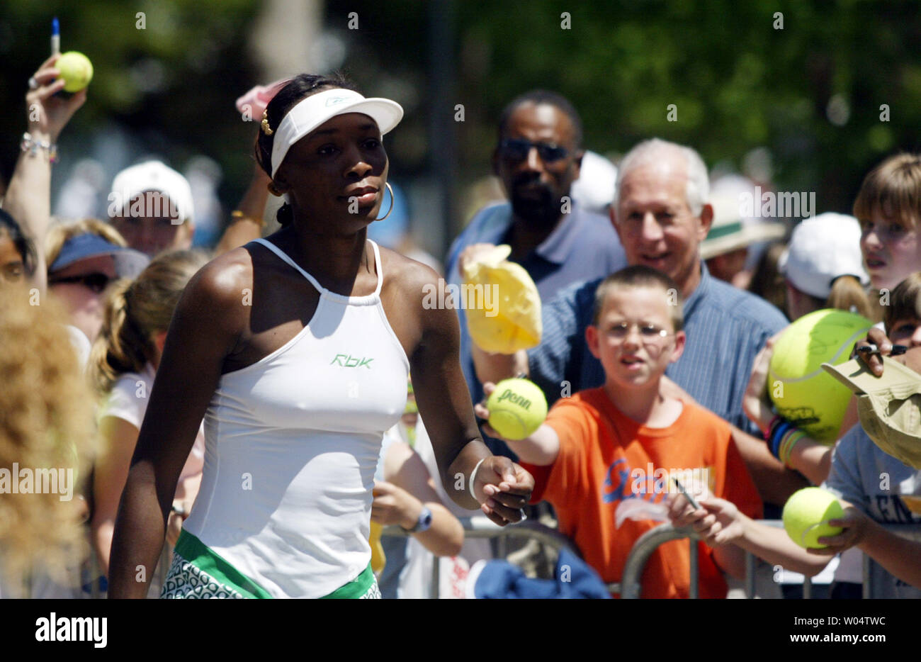 Venus Williams is greeted by fans seeking autographs after she defeated Jelena Kostanic 6-4, 6-1 in the semifinals of the Family Circle Cup in Charleston, S.C. on Saturday, April 17, 2004. (UPI Photo/Nell Redmond) Stock Photo