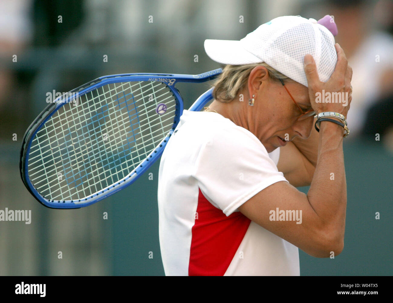 Martina Navratilova  adjusts her hat before serving in her semifinals doubles match at the Family Circle Cup in Charleston, S.C. on Saturday, April 17, 2004. (UPI Photo/Nell Redmond) Stock Photo