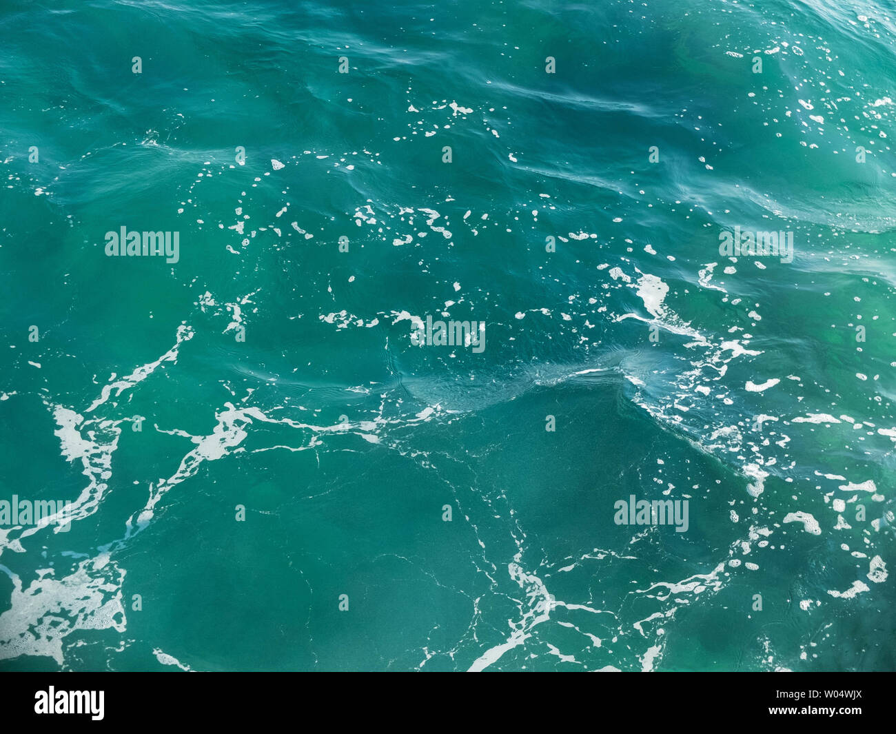 Splashing foamy waves on the sea surface Stock Photo - Alamy