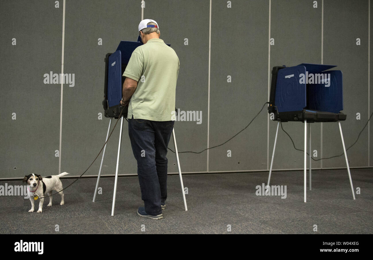 Allan Briggs, is joined by his dog Daisy, as he casts his vote in the South Carolina primary election, in Daniel Island, South Carolina on February 20, 2016. Photo by Kevin Dietsch/UPI Stock Photo