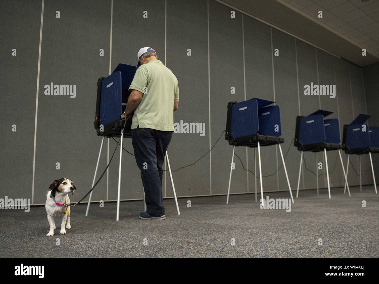 Allan Briggs, is joined by his dog Daisy, as he casts his vote in the South Carolina primary election, in Daniel Island, South Carolina on February 20, 2016. Photo by Kevin Dietsch/UPI Stock Photo