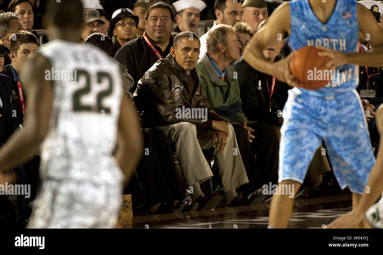 President Barack Obama watches the inaugural Quicken Loans Carrier Classic basketball game Friday, November 11, 2011 on the flight deck of the aircraft carrier USS Carl Vinson (CVN 70) in San Diego, California.   Michigan State University and the University of North Carolina tipped off the  Carrier Classic, which is a celebration of Veterans Day.   UPI/James R. Evans/Navy Stock Photo