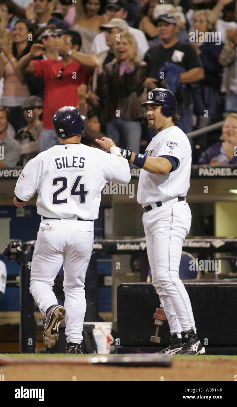 San Diego Padres right fielder Brian Giles is greeted by catcher Mike Piazza  as he crosses the plate to tie the game at 1-1 in the 5th inning of the  contest between