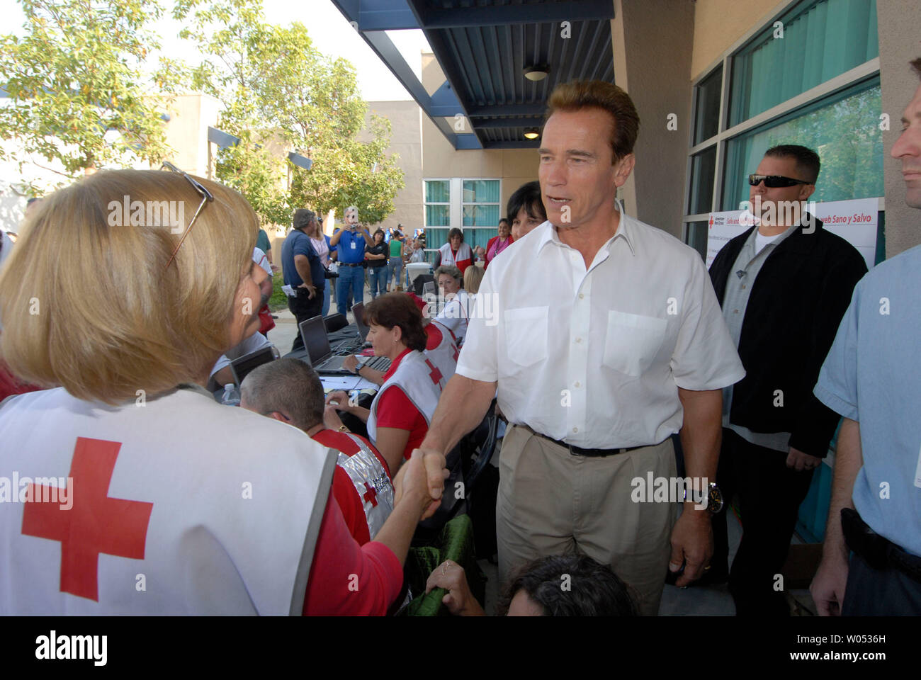 California Governor Arnold Schwarzenegger speaks with and thanks Red Cross workers at a Assistance Center set up in Rancho San Diego, California on October 28, 2007. The center was set up to help victims of the the Harris wildfire which killed 5 people, forced thousands to evacuate and destroyed hundreds of homes.  (UPI Photo/Earl Cryer). Stock Photo