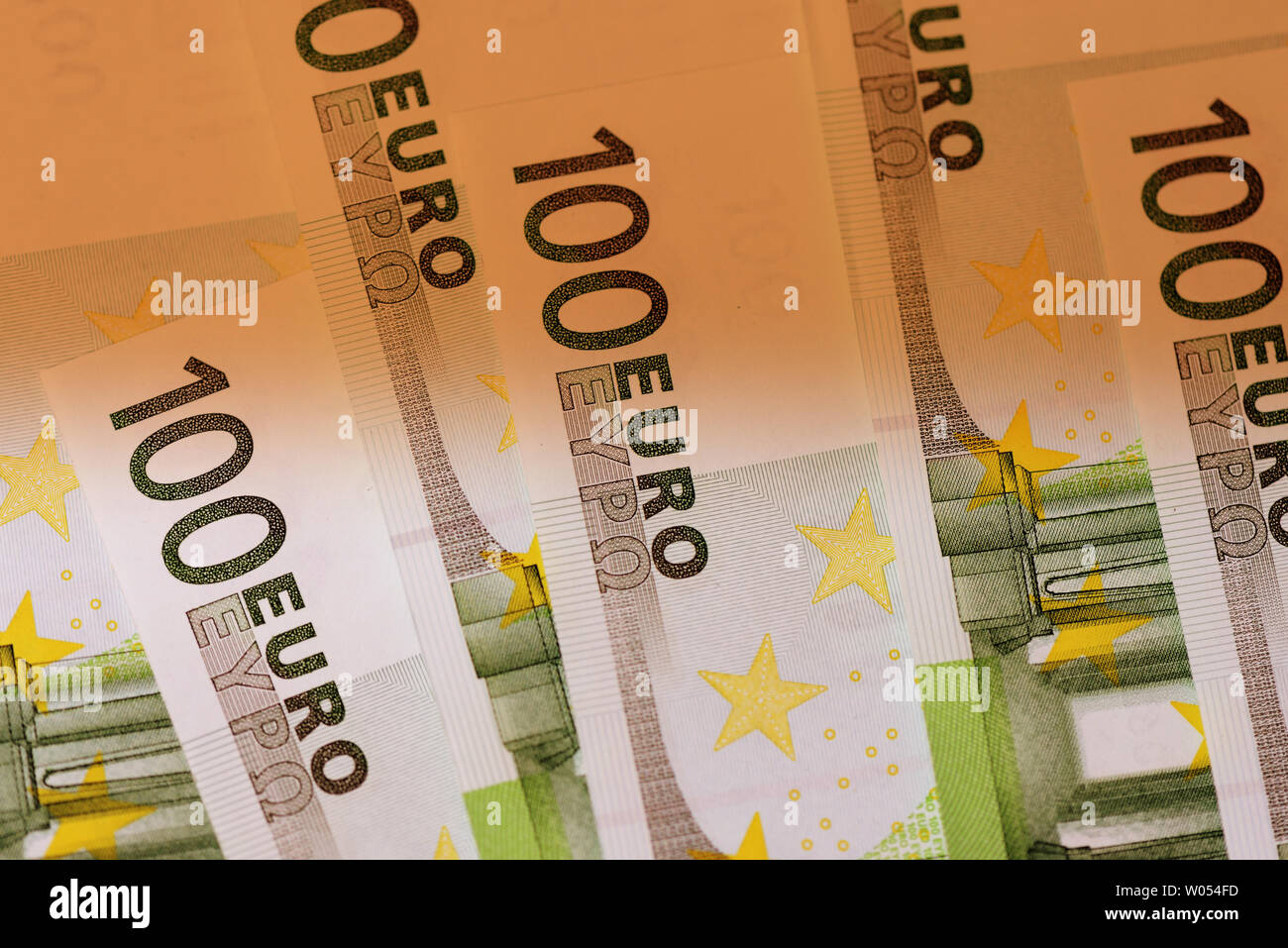 One hundred euro notes close up brown color toned Stock Photo - Alamy