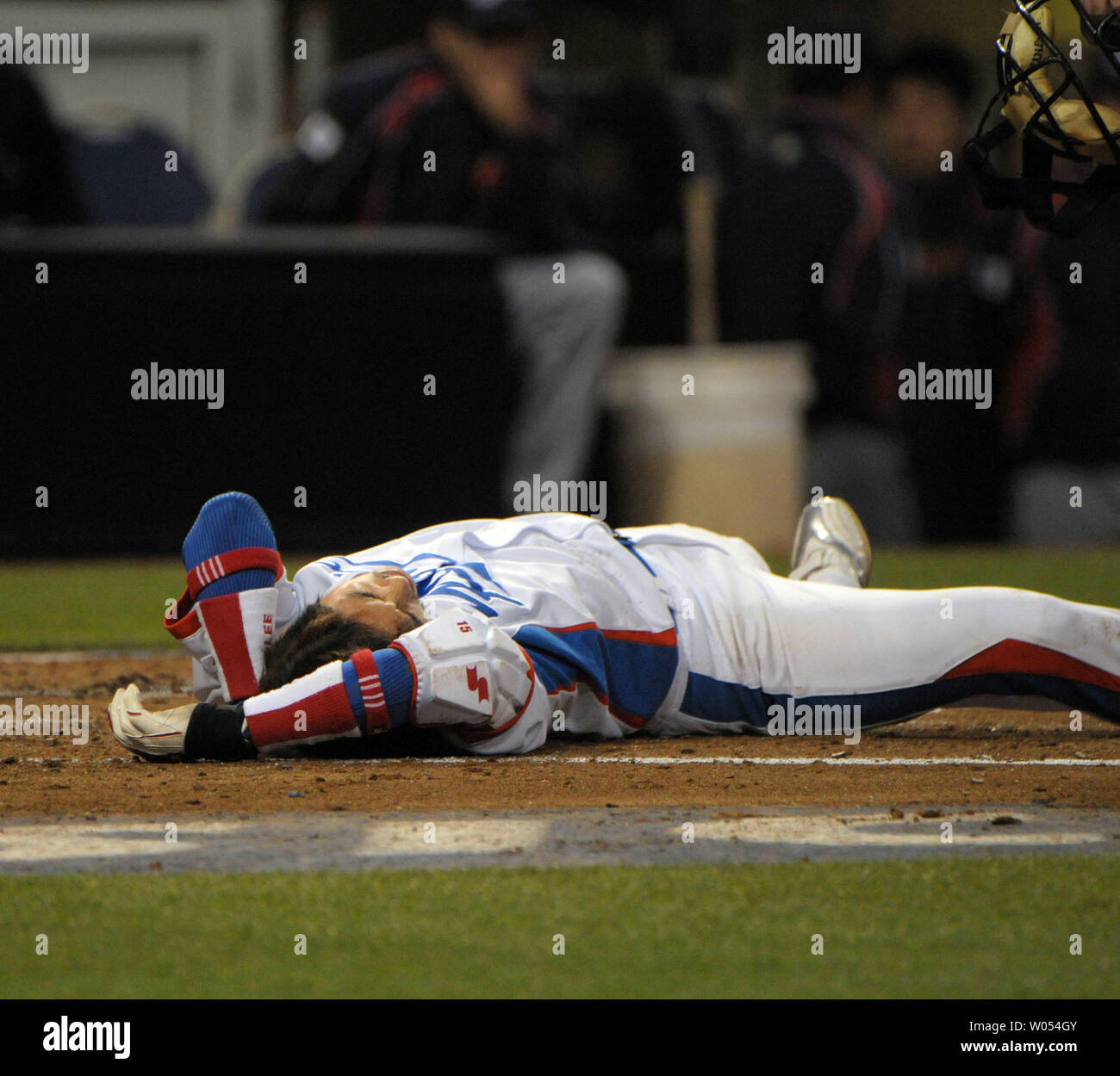 Lee Yong-Kyu of Team Korea holds his head after being hit by a pitch during the third inning against Team Japan during Round 2 of the World Baseball Classic in San Diego, March 19, 2009.  ( UPI Photo/Earl S. Cryer) Stock Photo