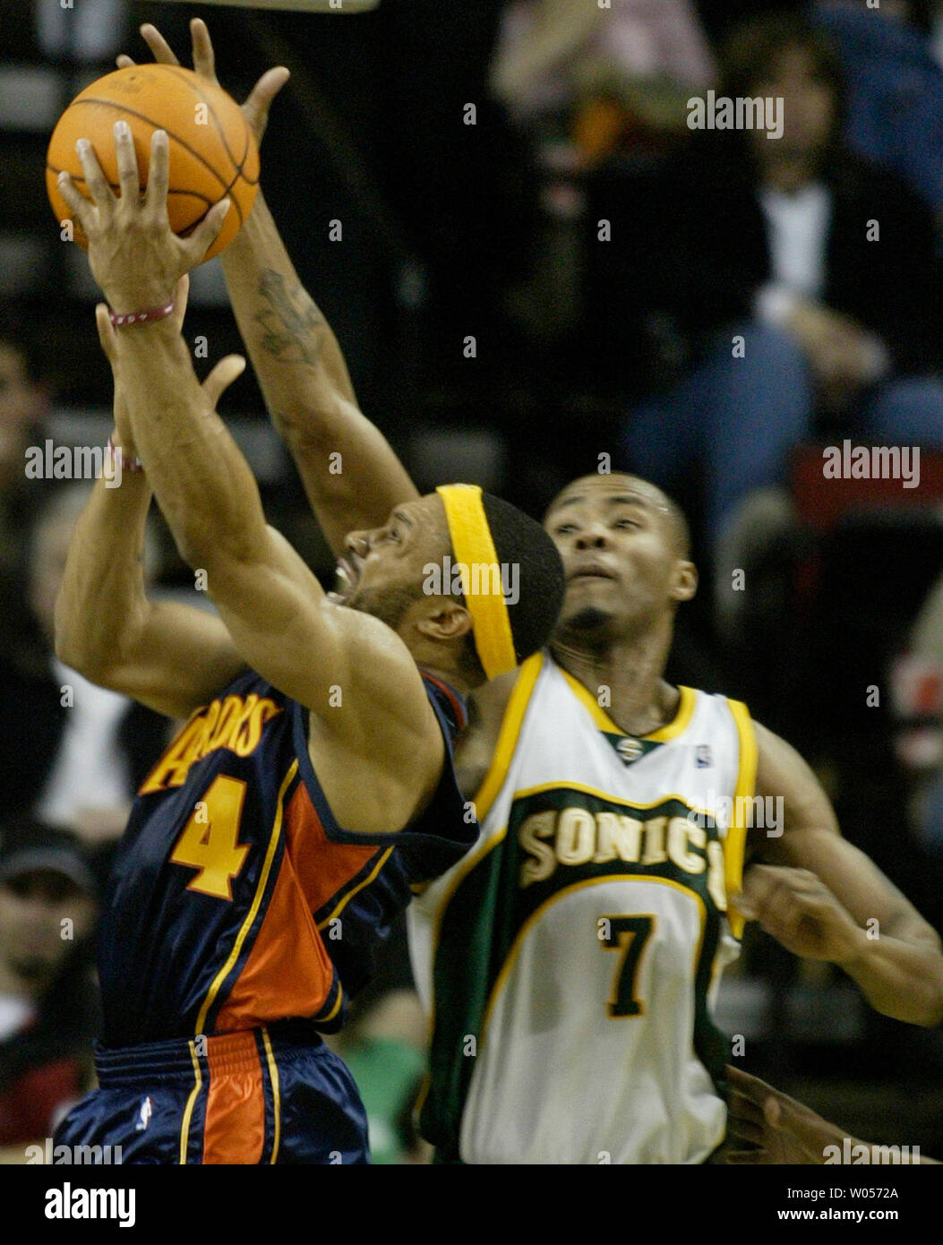 Golden State Warriors' Derek Fisher, left, hits a basket over the  outstretched arms of Seattle SuperSonics Rashard Lewis during the 2nd  quarter in Seattle on February 16, 2005. (UPI Photo/Jim Bryant Stock