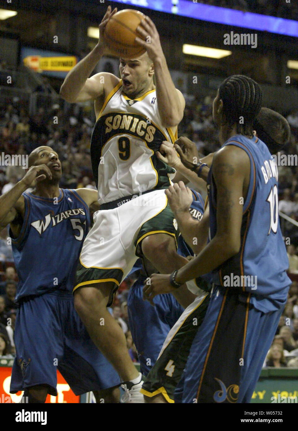 Seattle SuperSonics'  Vitaly Potapenko of the Ukraine, middle, pulls down a rebound against Washington Wizards' Michael Ruffin, left, and Damone Brown, right, in the first half in Seattle on March 27, 2005. (UPI Photo/Jim Bryant) Stock Photo