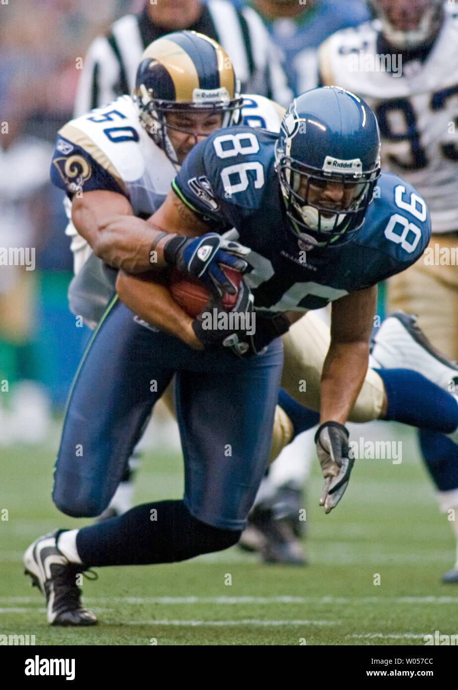 Seattle Seahawks tight end Jerramy Stevens (86) is tackled after an 18-yard gain by St. Louis Rams' linebacker Pisa Tinoisamoa in the first quarter at Qwest Field in Seattle on November 13, 2005. The Seahawks beat the Rams 31-16. (UPI Photo/Jim Bryant) Stock Photo