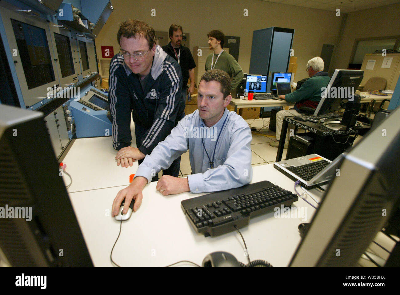 Adrian Hughes (R) and Dirk Lang (L) use a computer to test Avionics equipment in the Avionics Integration Lab at Boeing Field in Seattle on May 22, 2007.  The electrical and hydraulic systems for the all-new Boeing 787 Dreamliner aircraft will be installed at the Everett plant in August 2007. (UPI Photo/Jim Bryant) Stock Photo