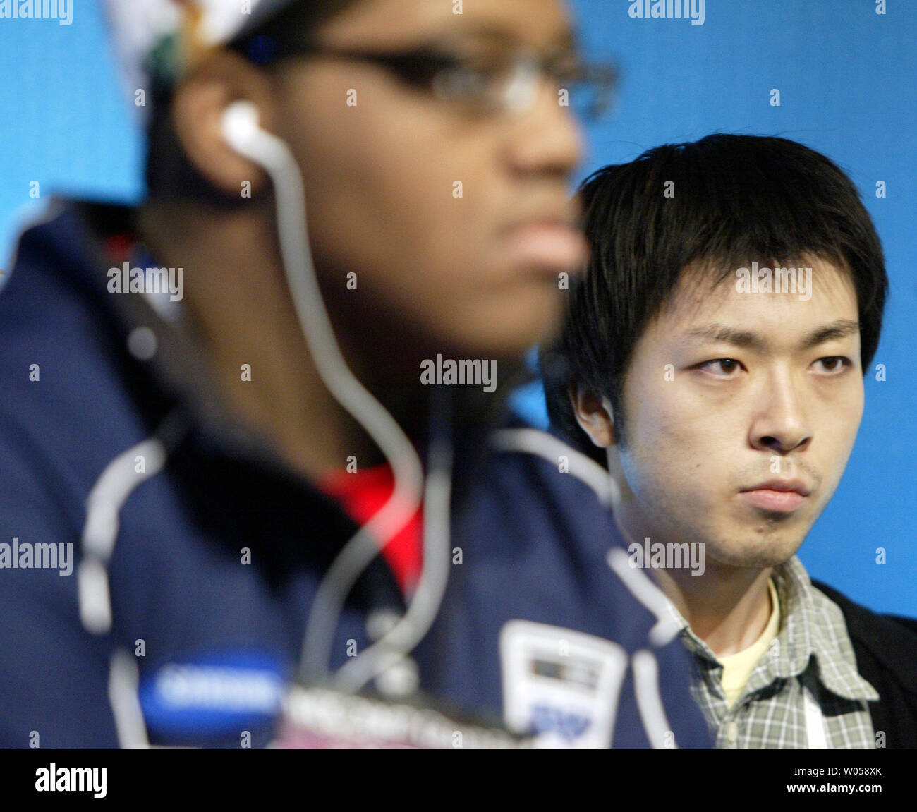 Tomoyuki Inui (R), of Japan, watches the screen as he plays Jeremy Florence, of the United States in 'Dead or Alive 4' during the World Cyber Games 2007 Grand Finals in Seattle on October 5, 2007. Over 700 players from 74 countries are participating in the four day grand finals for medals, prizes and 00,000. Florence beat Inui to advance in competition. (UPI Photo/Jim Bryant). Stock Photo