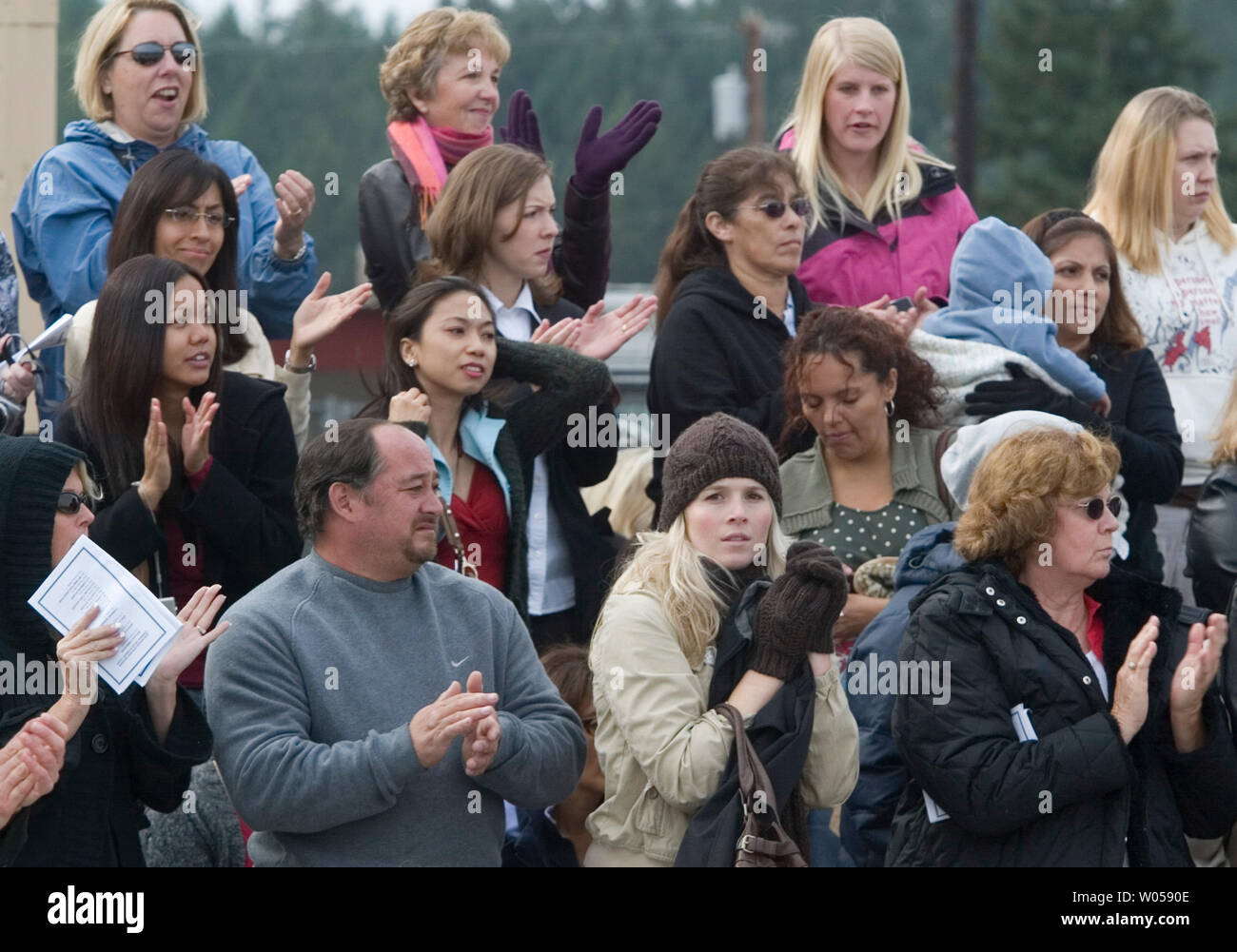 Friends and family members clap during welcome home ceremonies for the 3rd Brigade, 2nd Infantry Division at Fort Lewis in Tacoma, Washington on October 11, 2007. Soldiers from the 3rd Stryker Brigade were deployed in Iraq from June 2006 to September 2007. (UPI Photo/Jim Bryant) Stock Photo