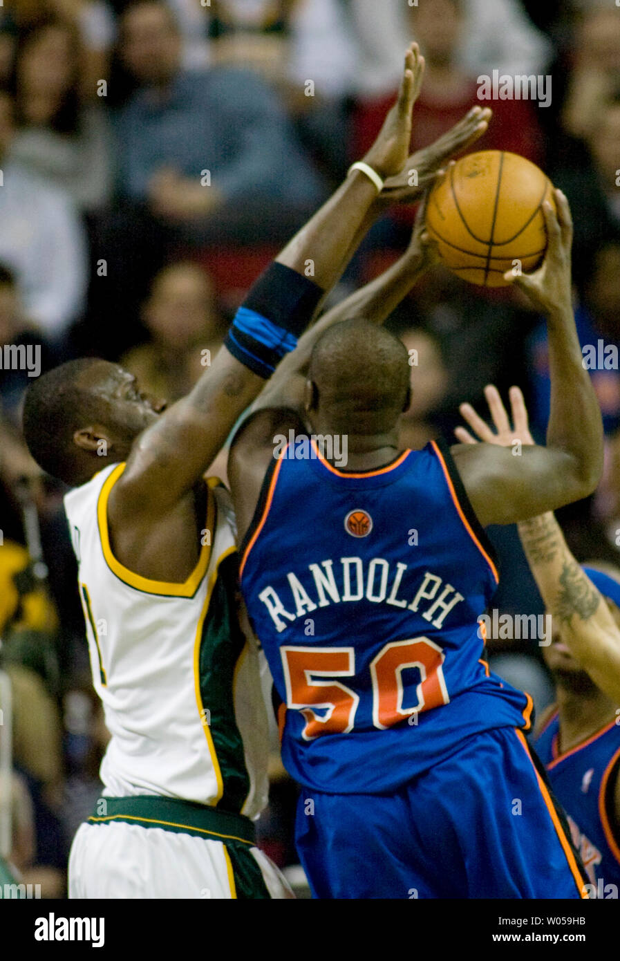 New York Knicks' Zach Randolph (R) is fouled by Seattle SuperSonics'  Johan Petro, of France, during the second half at the Key Arena in Seattle on February 2, 2008. Randolph led all scorers with 24 points in the Knicks 85-86 loss to the SuperSonics. (UPI Photo/Jim Bryant) Stock Photo