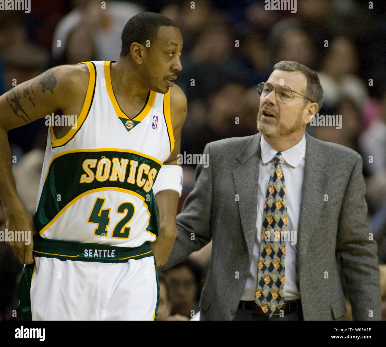 Seattle SuperSonics' head coach P.J. Carlesimo (R) talks to Donyell Marshall as he gets ready to go onto the court during the second half at the Key Arena in Seattle on March 30, 2008. The Kings beat the SuperSonics 120-107.  (UPI Photo/Jim Bryant) Stock Photo