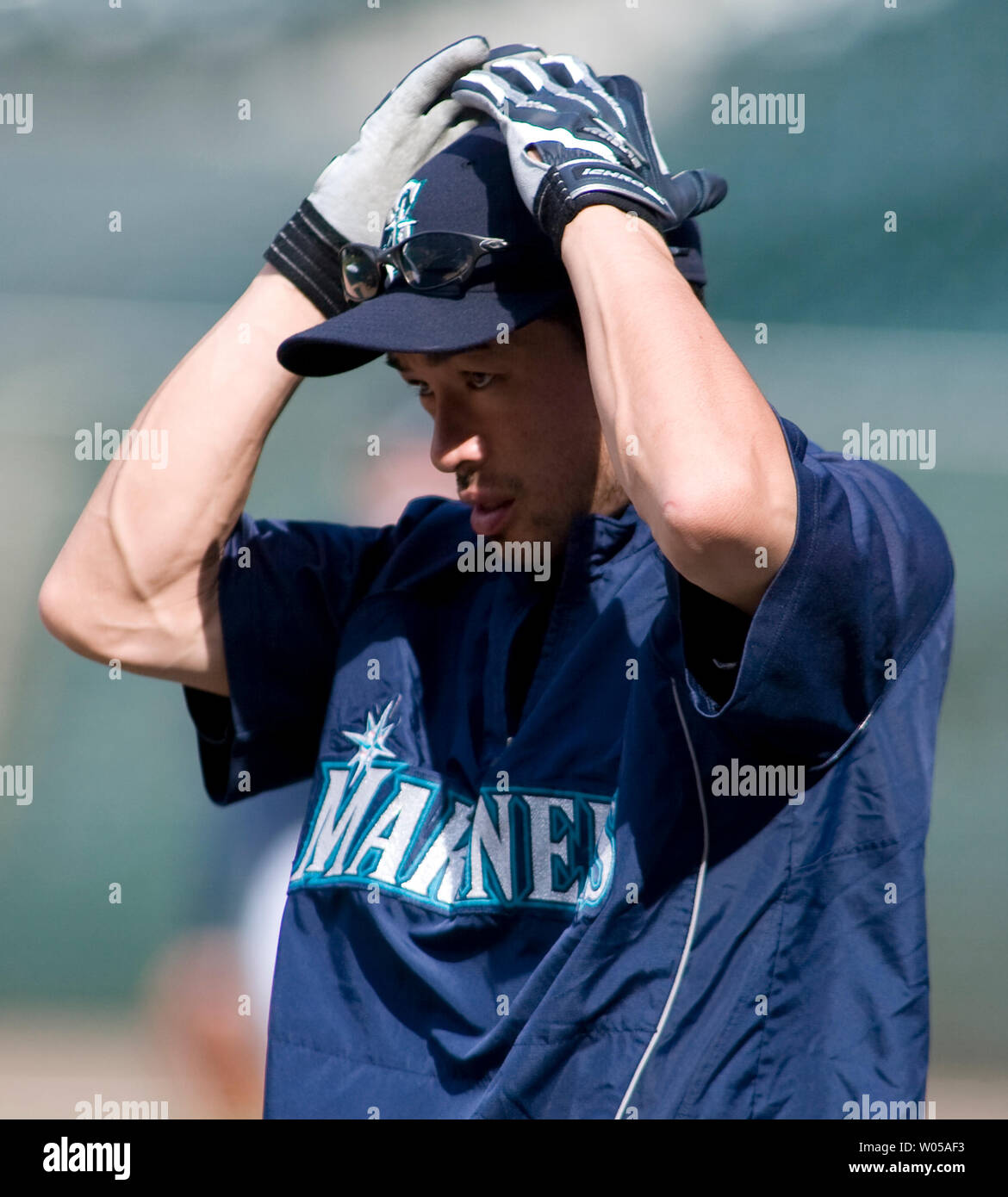 Seattle Mariners' Ichiro Suzuki, of Japan, adjusts his hat before