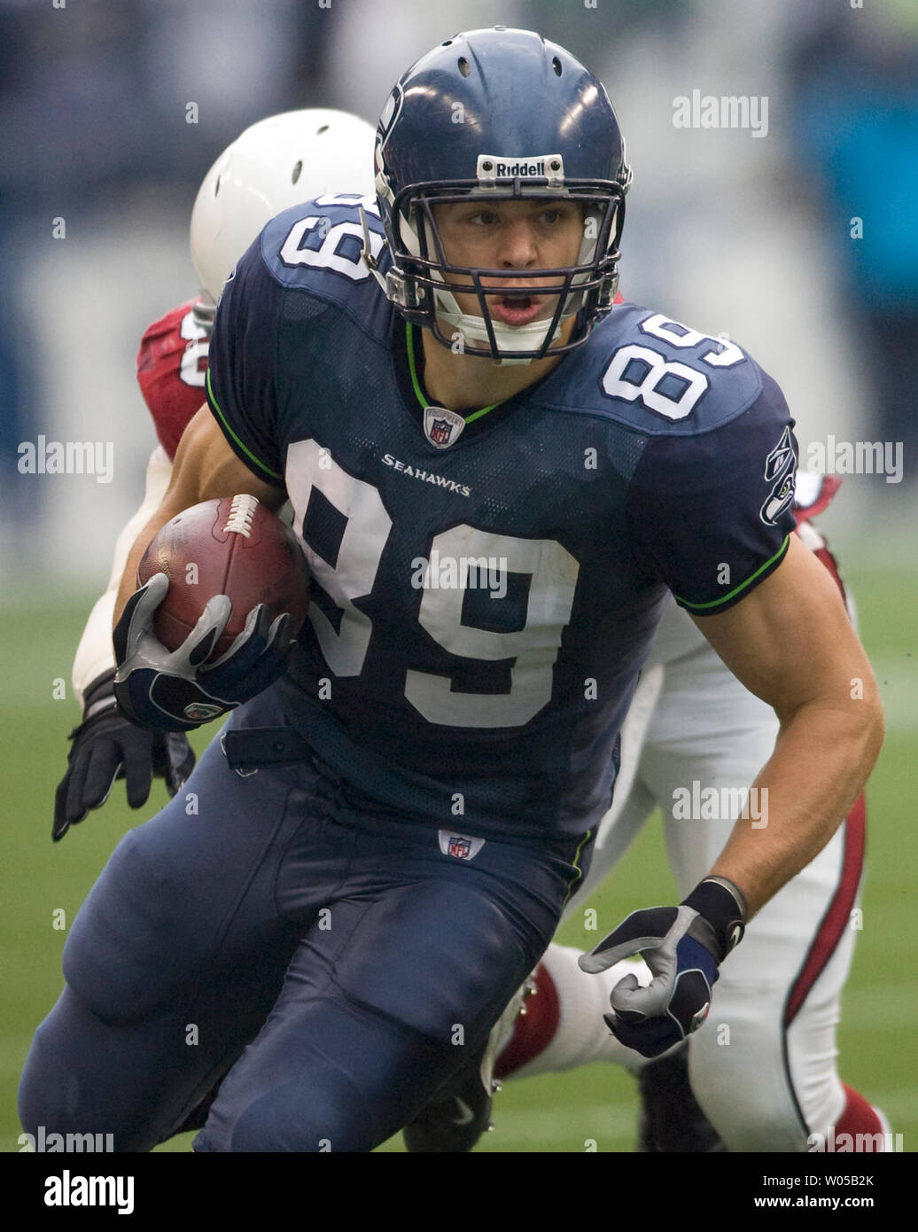 Seattle Seahawks tight end John Carlson heads upfield after catching a  25-yard pass against defending Arizona Cardinals linebacker Chike Okeafor  (L) in the third quarter at Qwest Field in Seattle on November