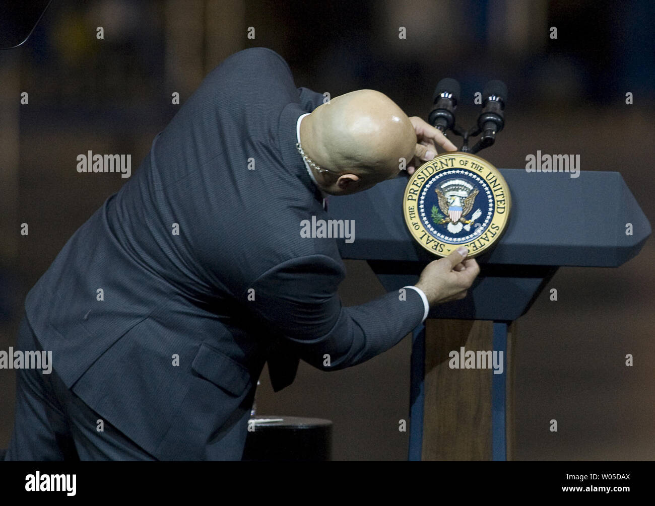 A Secret Service agent attaches the Presidential Seal to a podium before President Barack Obama speak to Boeing employees about his blueprint for an economy built to last, based on American domestic manufacturing and promoting American exports,  at the aerospace giant's assembly facility in Everett, Washington on February 17, 2012. Later Obama will be attending two fund raising events for his re-election campaign.   UPI/Jim Bryant Stock Photo