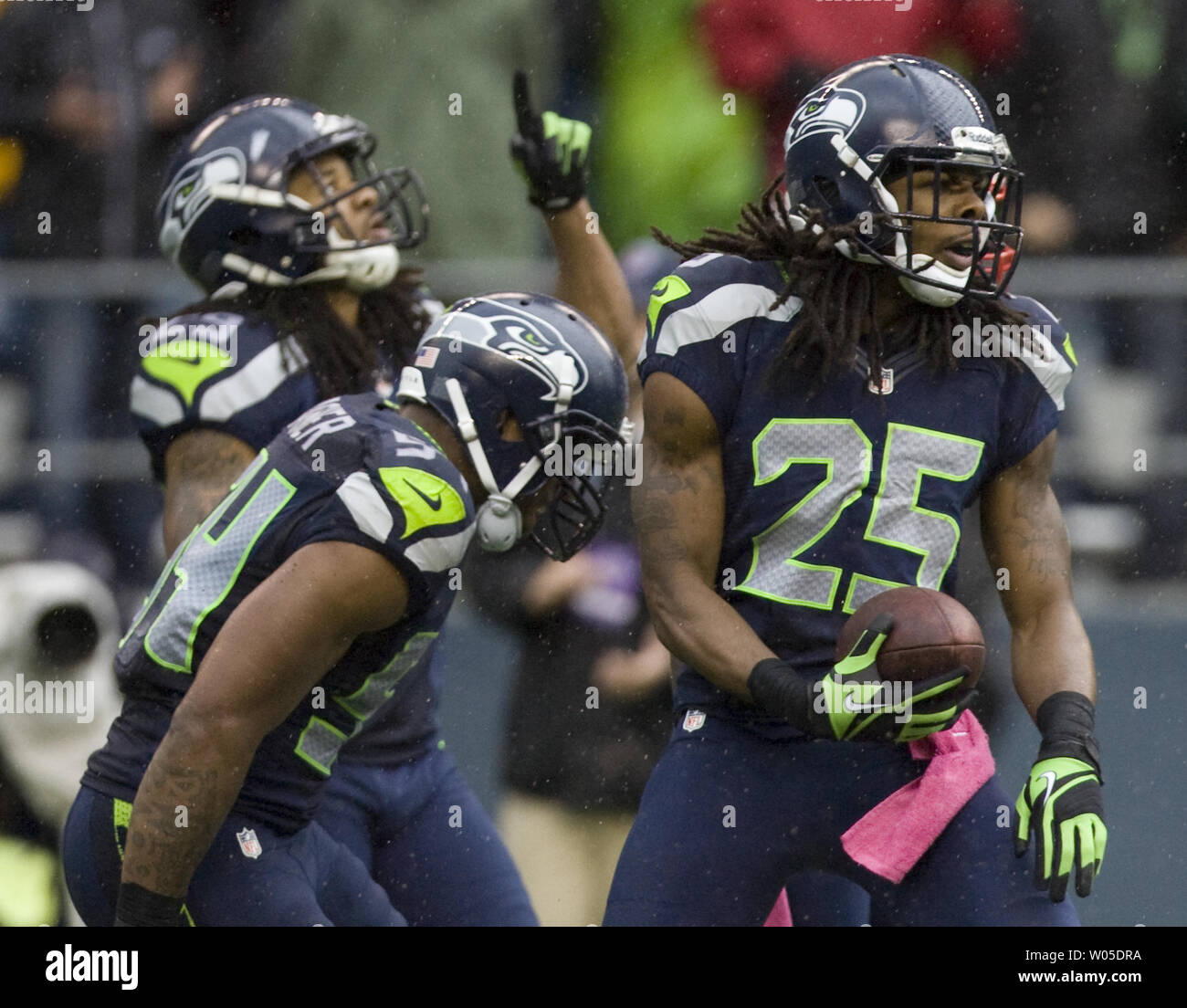Seattle Seahawks defenders Bobby Wagner, (54), Marcus Trufant, (23)  cerebrate with Richard Sherman after he intercepted a New England Patriots  pass at CenturyLink Field in Seattle, Washington on October 14, 2012. With