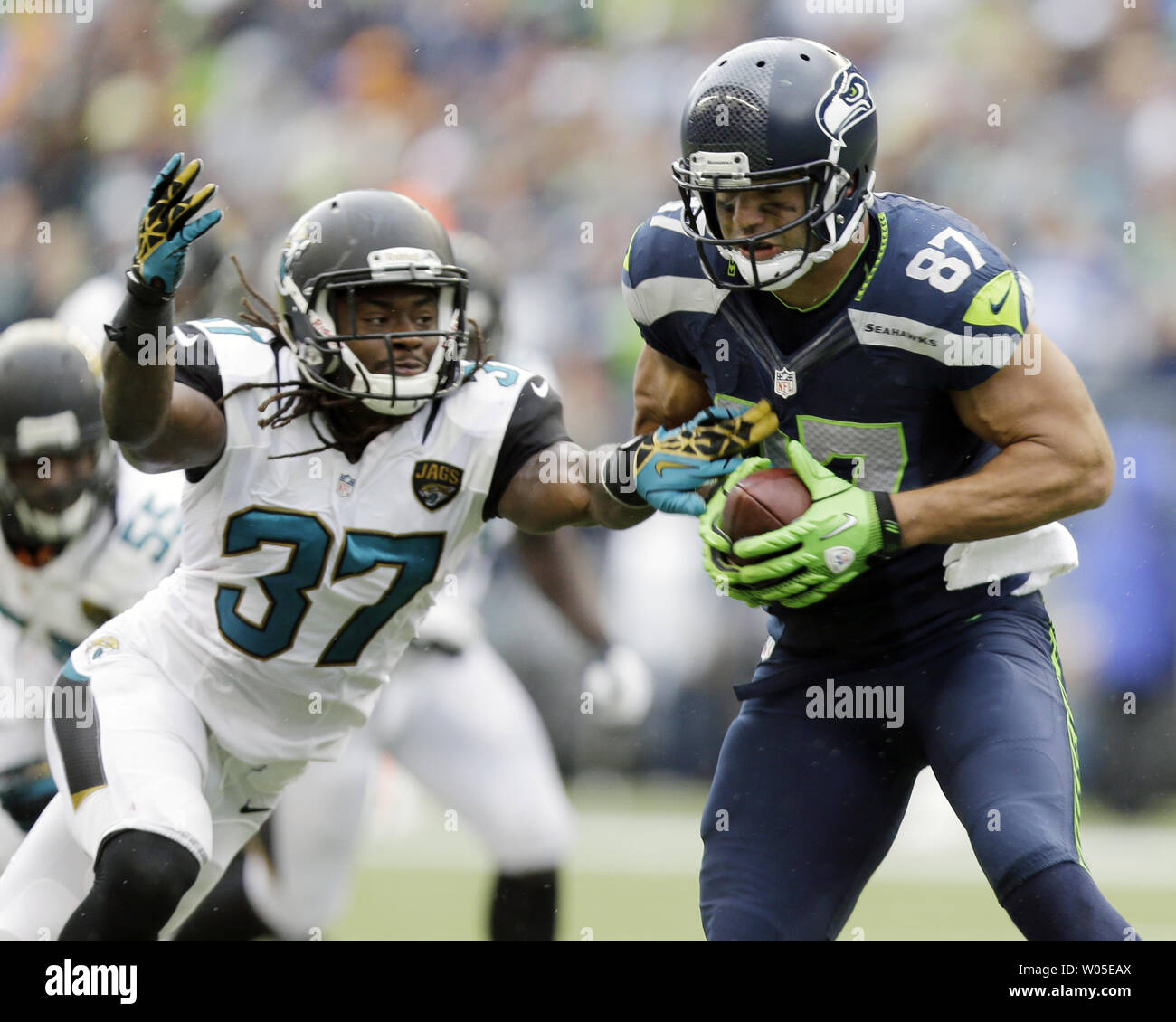 Seattle Seahawks tight end Kellen Davis catches an 8-yard pass from  quarterback Russell Wilson before getting hit by Jacksonville Jaguars  safety Johnathan Cyprien (37) during the third quarter at CenturyLink Field  in