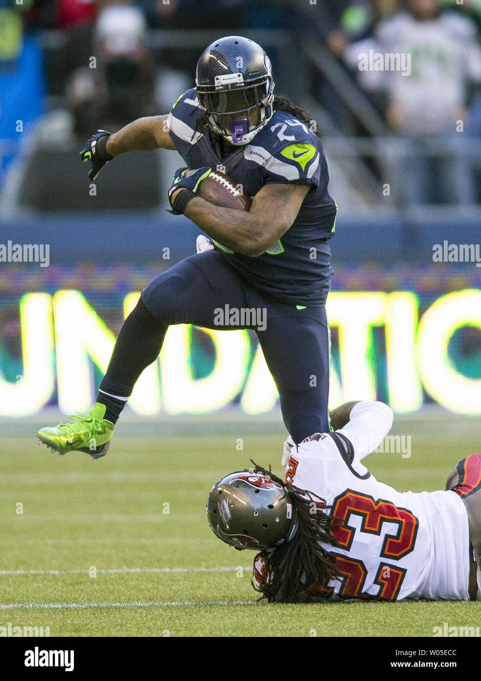 Seattle Seahawks running back Marshawn Lynch (24) leaps over Tampa Bay Buccaneers safety Mark Barron in the third quarter at CenturyLink Field in Seattle, Washington on November 3, 2013.  Lynch ran for 125 yards On 21 carries in the Seahawks 27-24 overtime win against the  Buccaneer. UPI /Jim Bryant Stock Photo